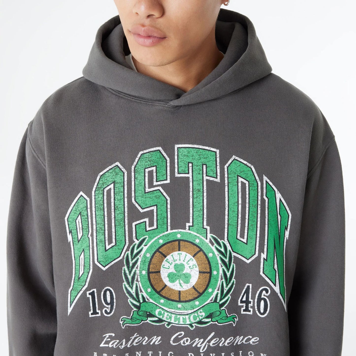 The Male model is wearing Boston Celtics Oversized Essential Dark Grey Oversized Pullover Hoodie 3