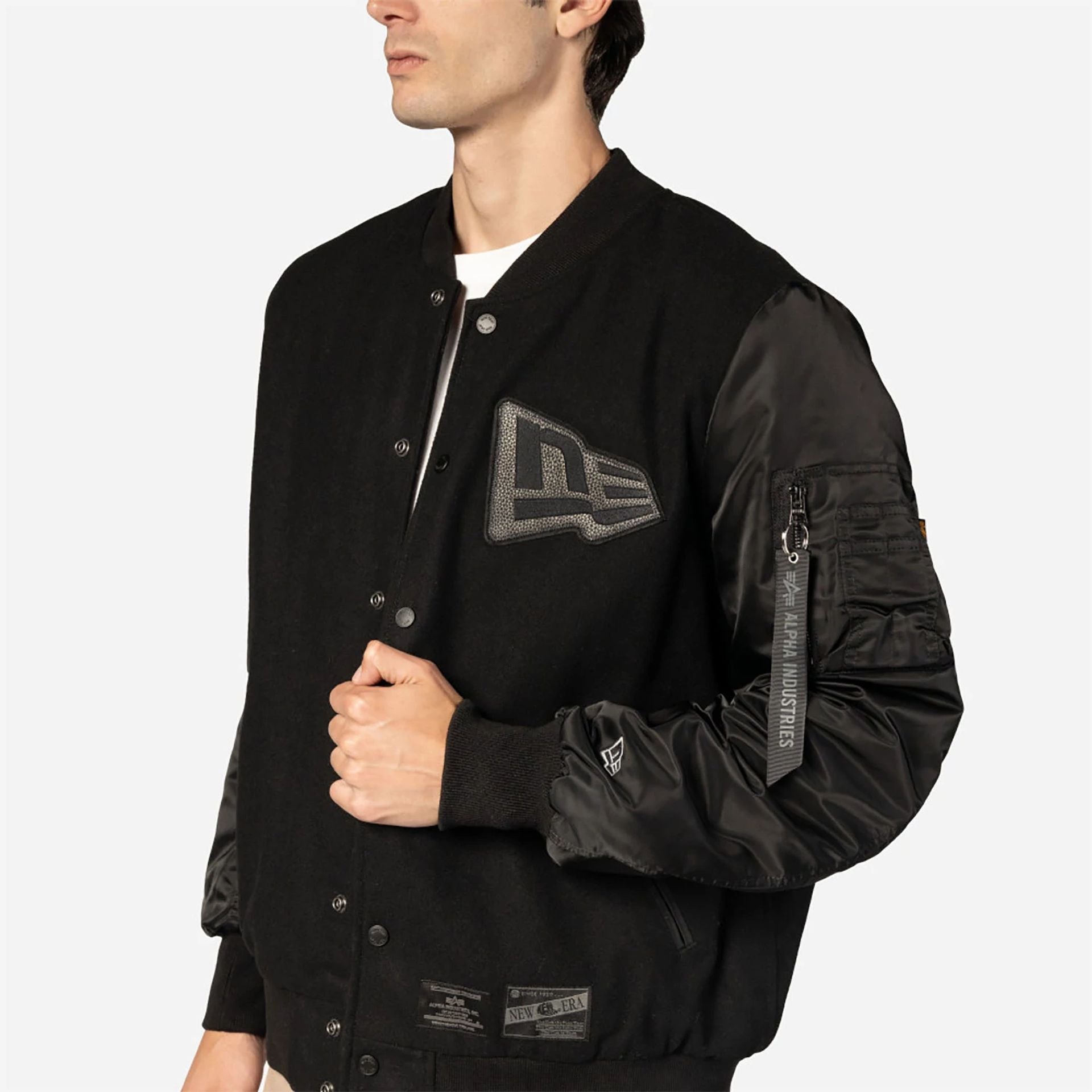 The Male model is wearing New Era x Alpha Industries Black Varsity Jacket 5