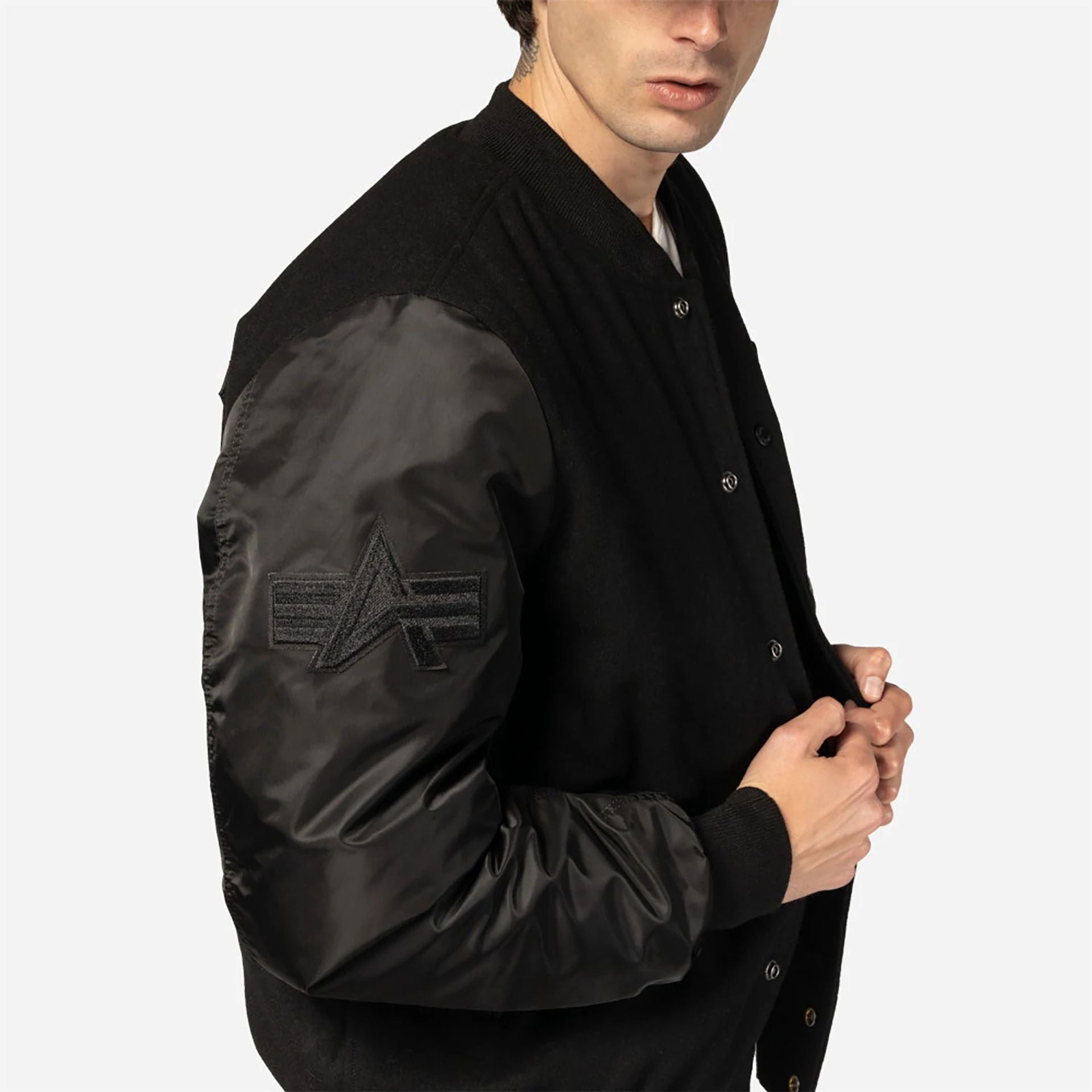 The Male model is wearing New Era x Alpha Industries Black Varsity Jacket 6