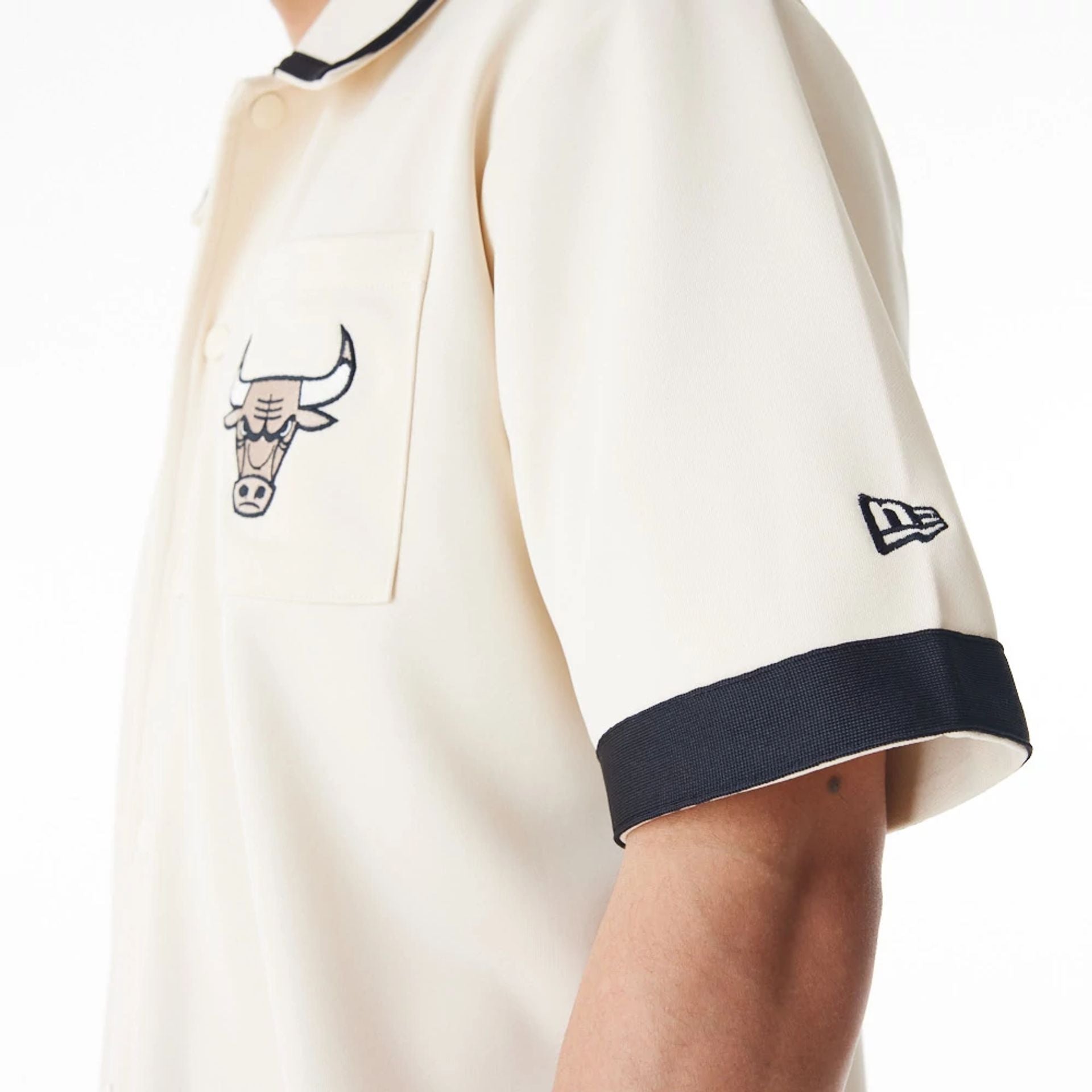 The Male model is wearing Chicago Bulls NBA Lifestyle Revere Light Beige Short Sleeve Shirt 11