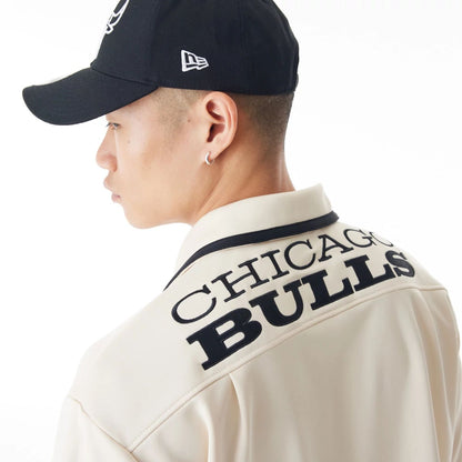 The Male model is wearing Chicago Bulls NBA Lifestyle Revere Light Beige Short Sleeve Shirt 12