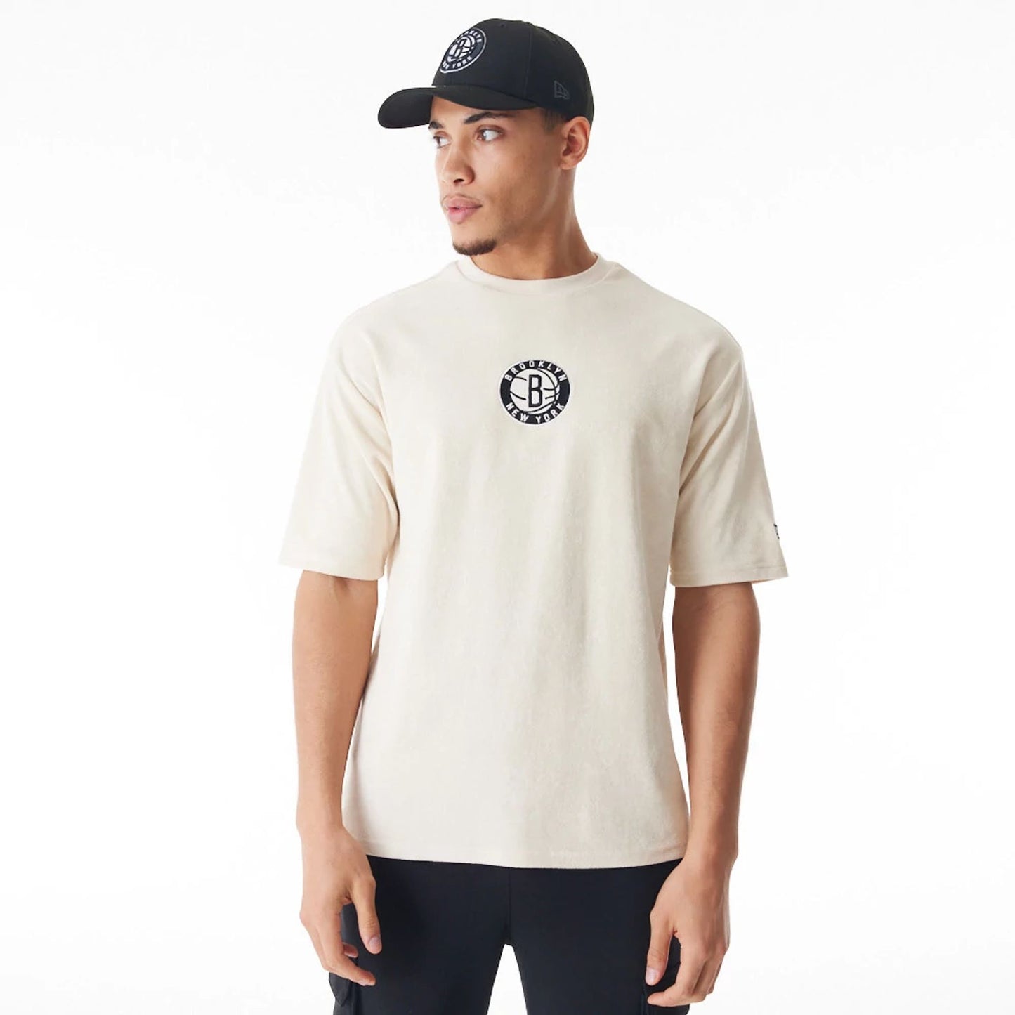 The Male model is wearing Brooklyn Nets NBA Lifestyle Velour Light Beige Oversized T-Shirt  1