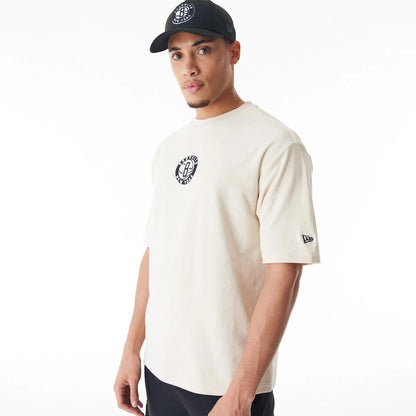 The Male model is wearing Brooklyn Nets NBA Lifestyle Velour Light Beige Oversized T-Shirt  9