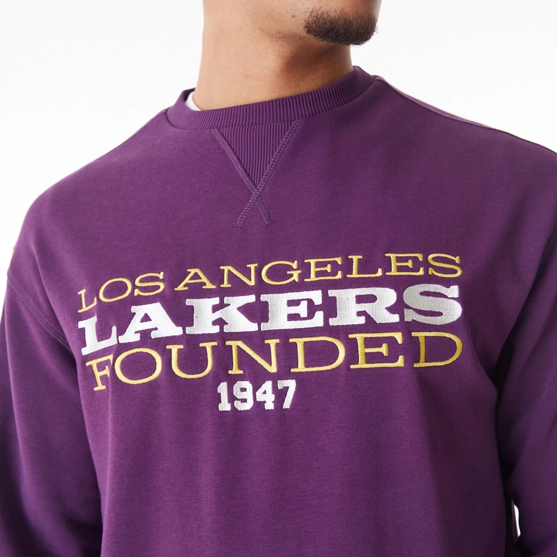 The Male model is wearing LA Lakers NBA Lifestyle Dark Purple Oversized Crew Neck Sweater  1