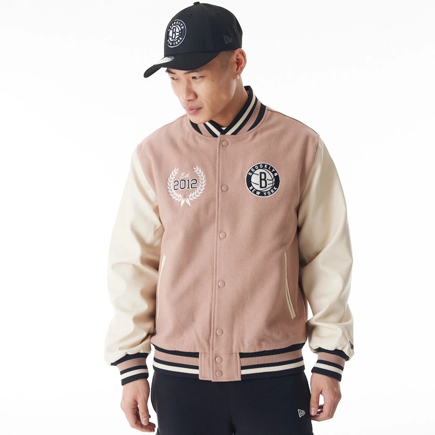 The Male model is wearing Brooklyn Nets NBA Lifestyle Beige Varsity Jacket  1