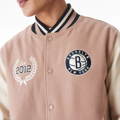 The Male model is wearing Brooklyn Nets NBA Lifestyle Beige Varsity Jacket  4