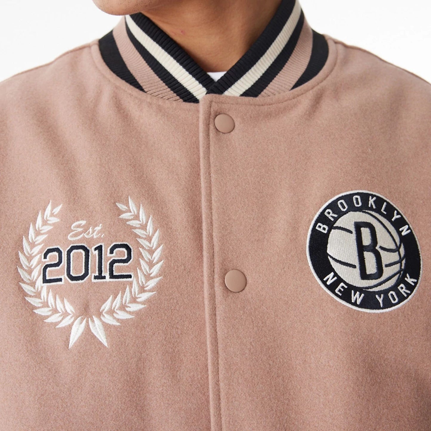 The Male model is wearing Brooklyn Nets NBA Lifestyle Beige Varsity Jacket  3