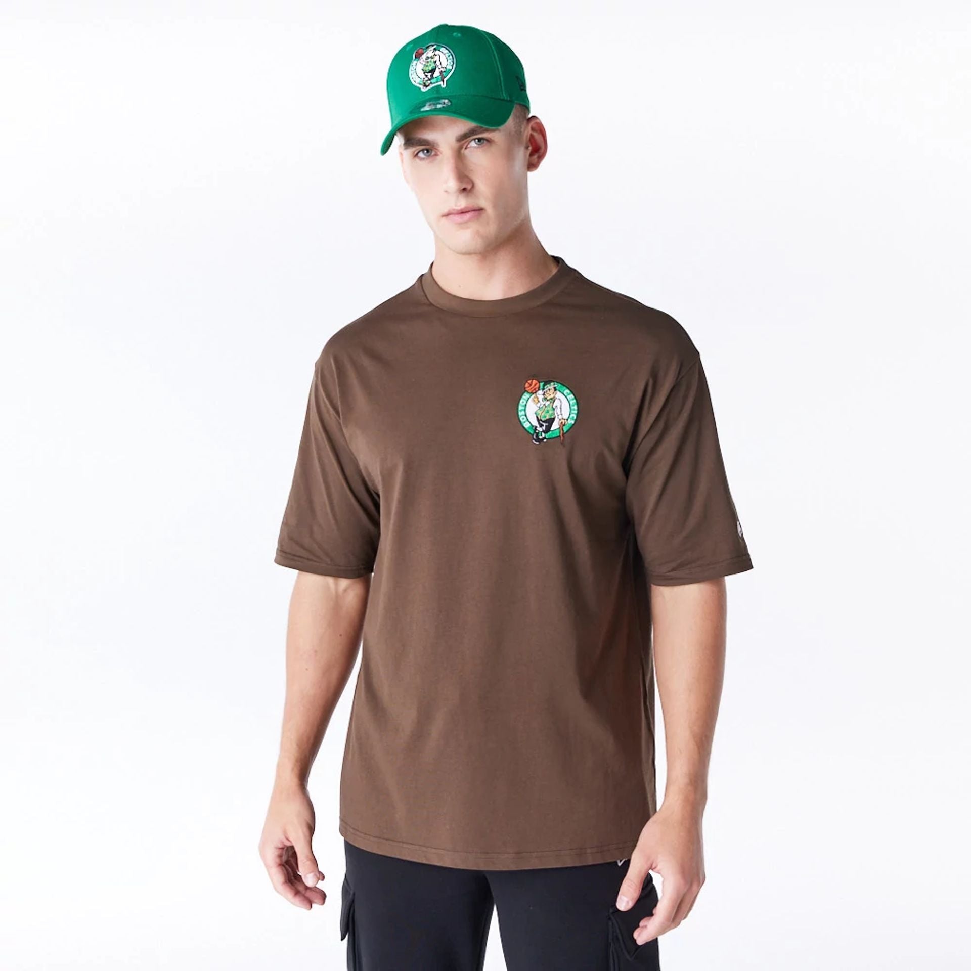 The Male model is wearing Boston Celtics League Essential Dark Brown Oversized T-Shirt  1