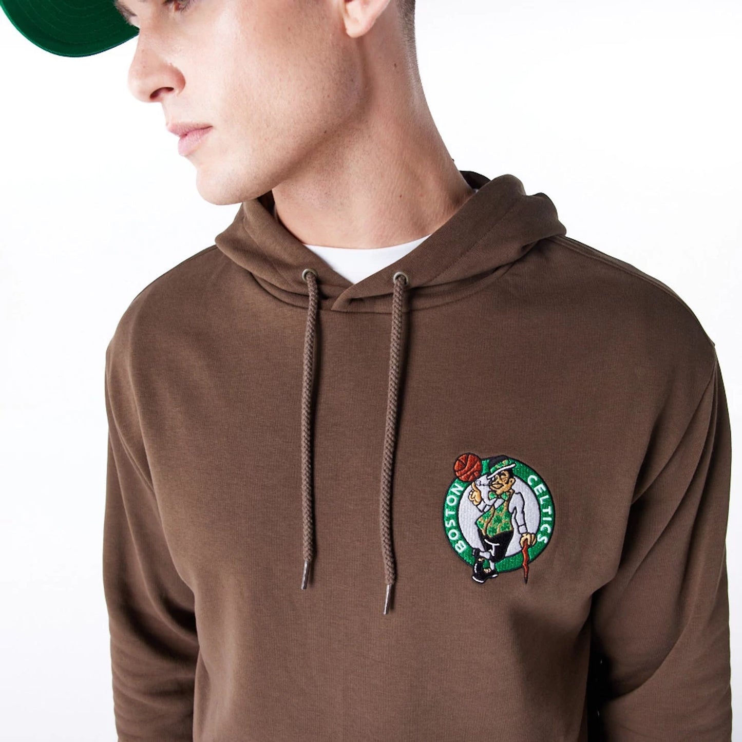 The Male model is wearing Boston Celtics League Essential Dark Brown Oversized Pullover Hoodie  2