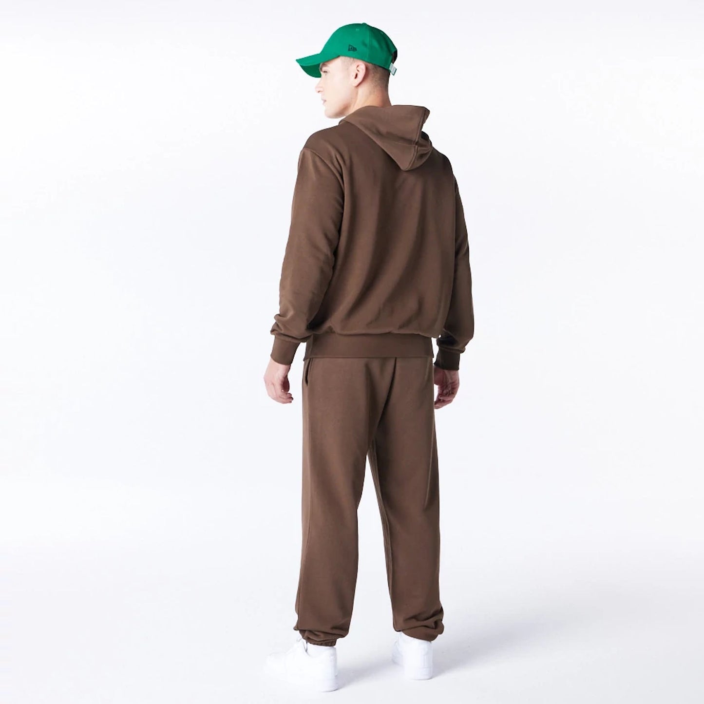 The Male model is wearing Boston Celtics League Essential Dark Brown Oversized Pullover Hoodie  3