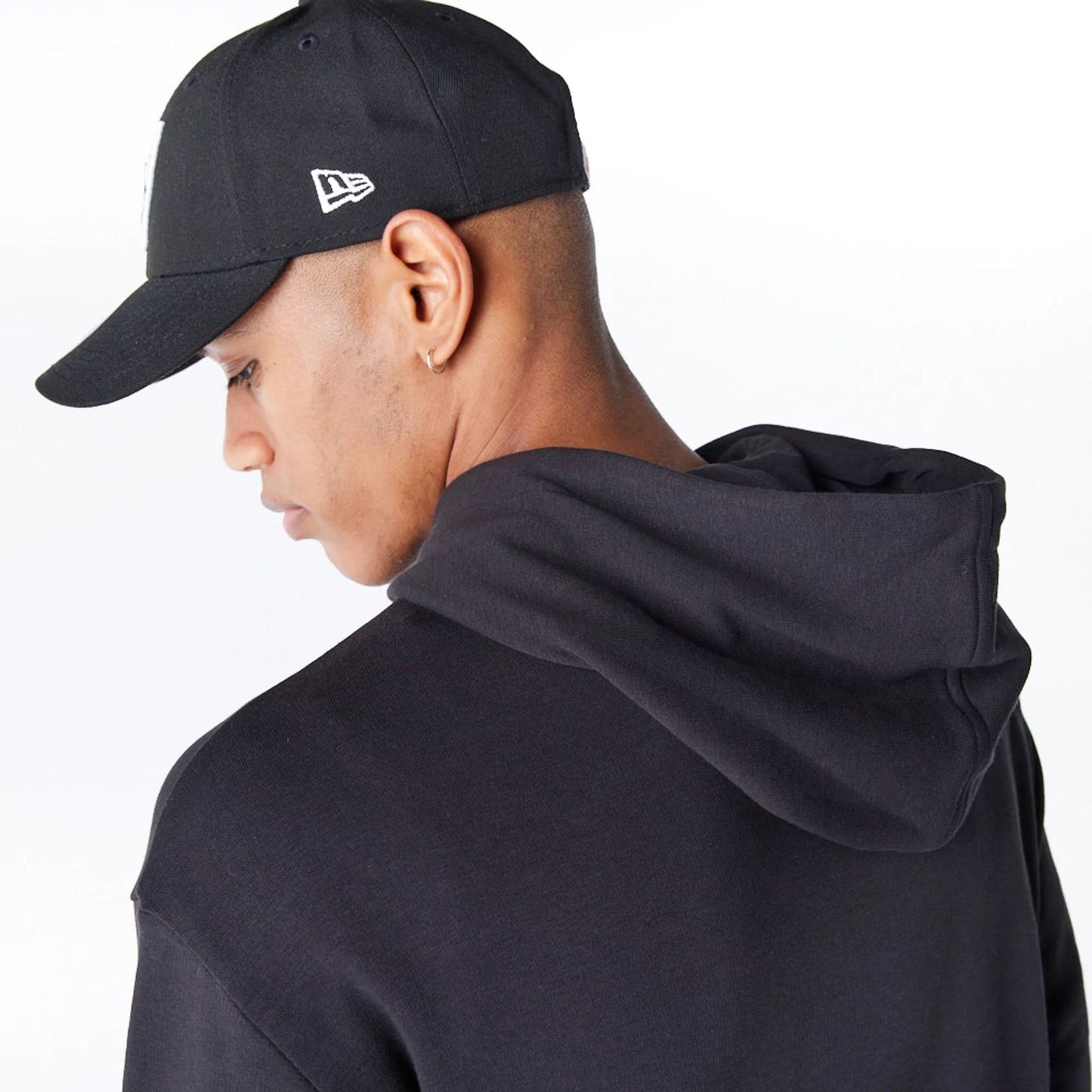 The Male model is wearing Las Vegas Raiders NFL League Essential Black Oversized Pullover Hoodie  3