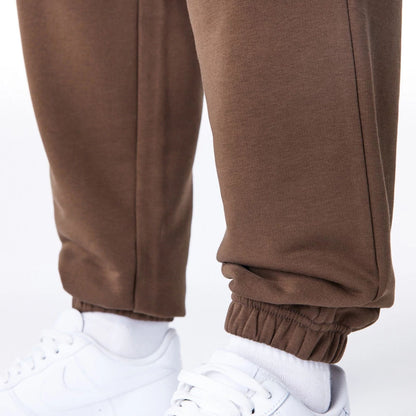 The Male model is wearing Boston Celtics League Essential Dark Brown Track Joggers  4