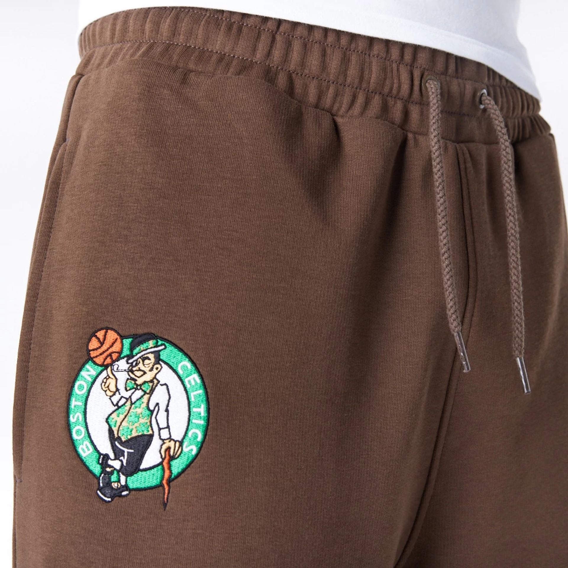 The Male model is wearing Boston Celtics League Essential Dark Brown Track Joggers  2