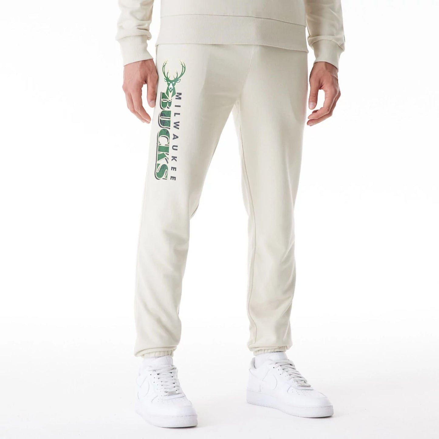 The Male model is wearing Milwaukee Bucks NBA Graphic Cream Joggers  1