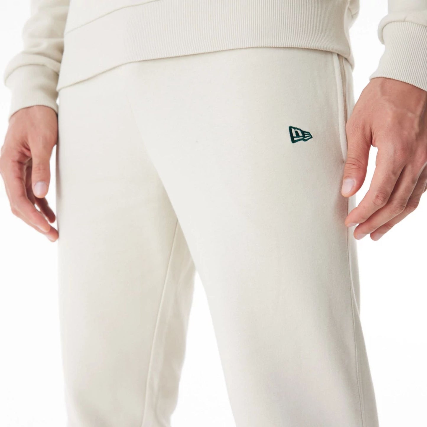 The Male model is wearing Milwaukee Bucks NBA Graphic Cream Joggers  8