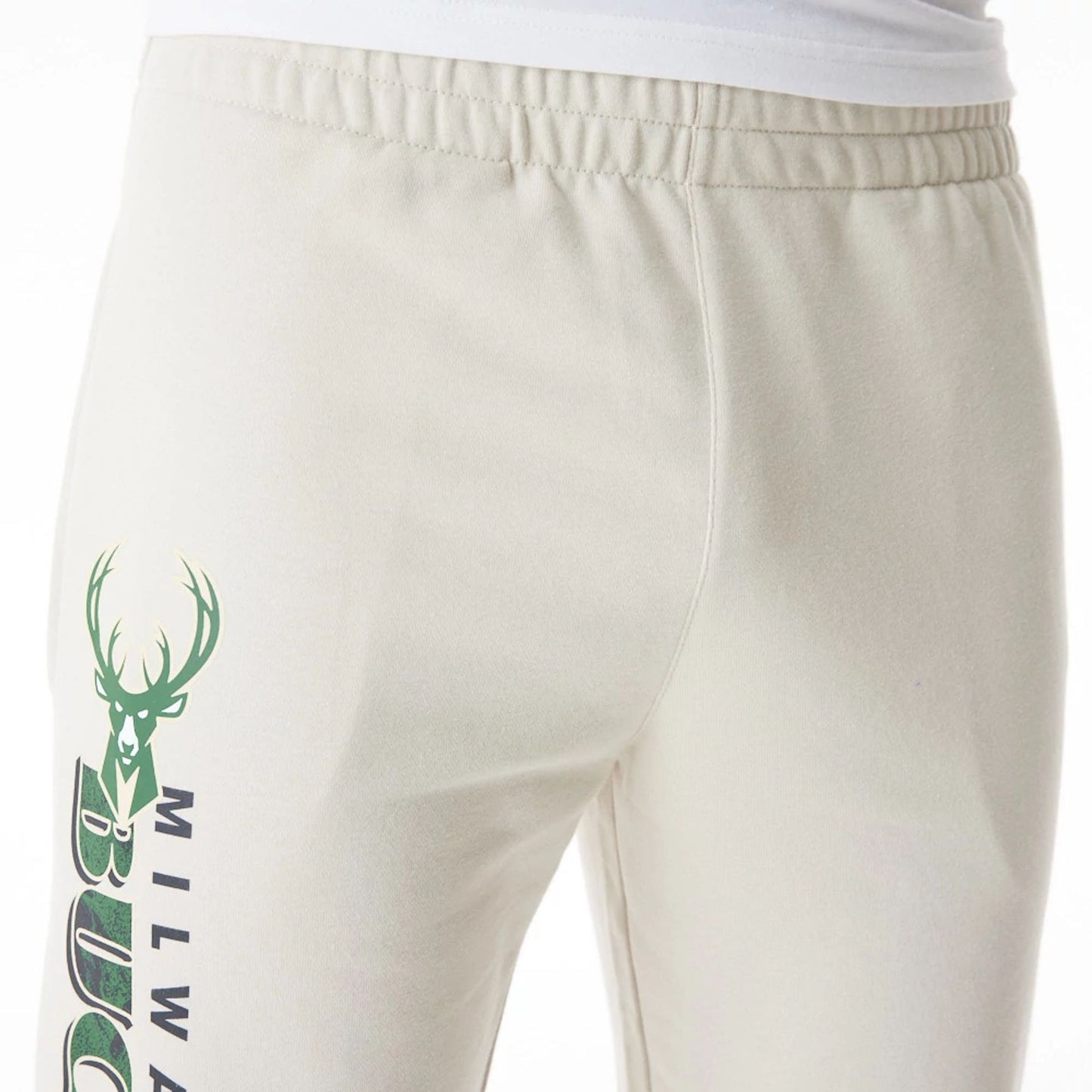 The Male model is wearing Milwaukee Bucks NBA Graphic Cream Joggers  7