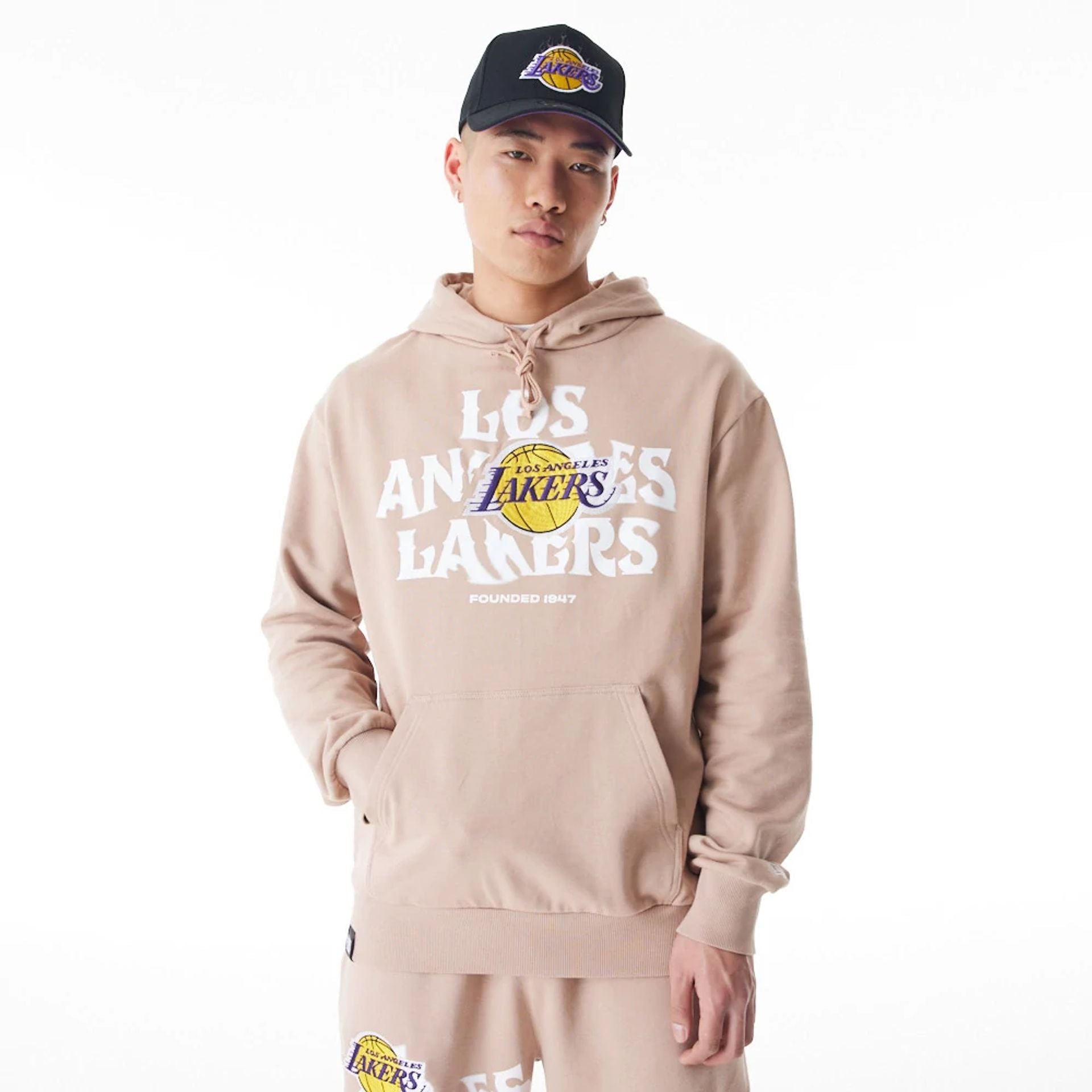 The Male model is wearing LA Lakers NBA Graphic Beige Oversized Pullover Hoodie  1