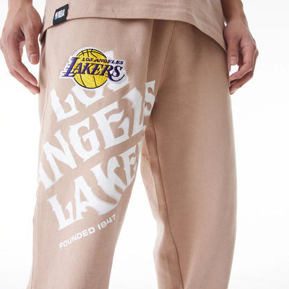 The Male model is wearing LA Lakers NBA Graphic Beige Joggers  8