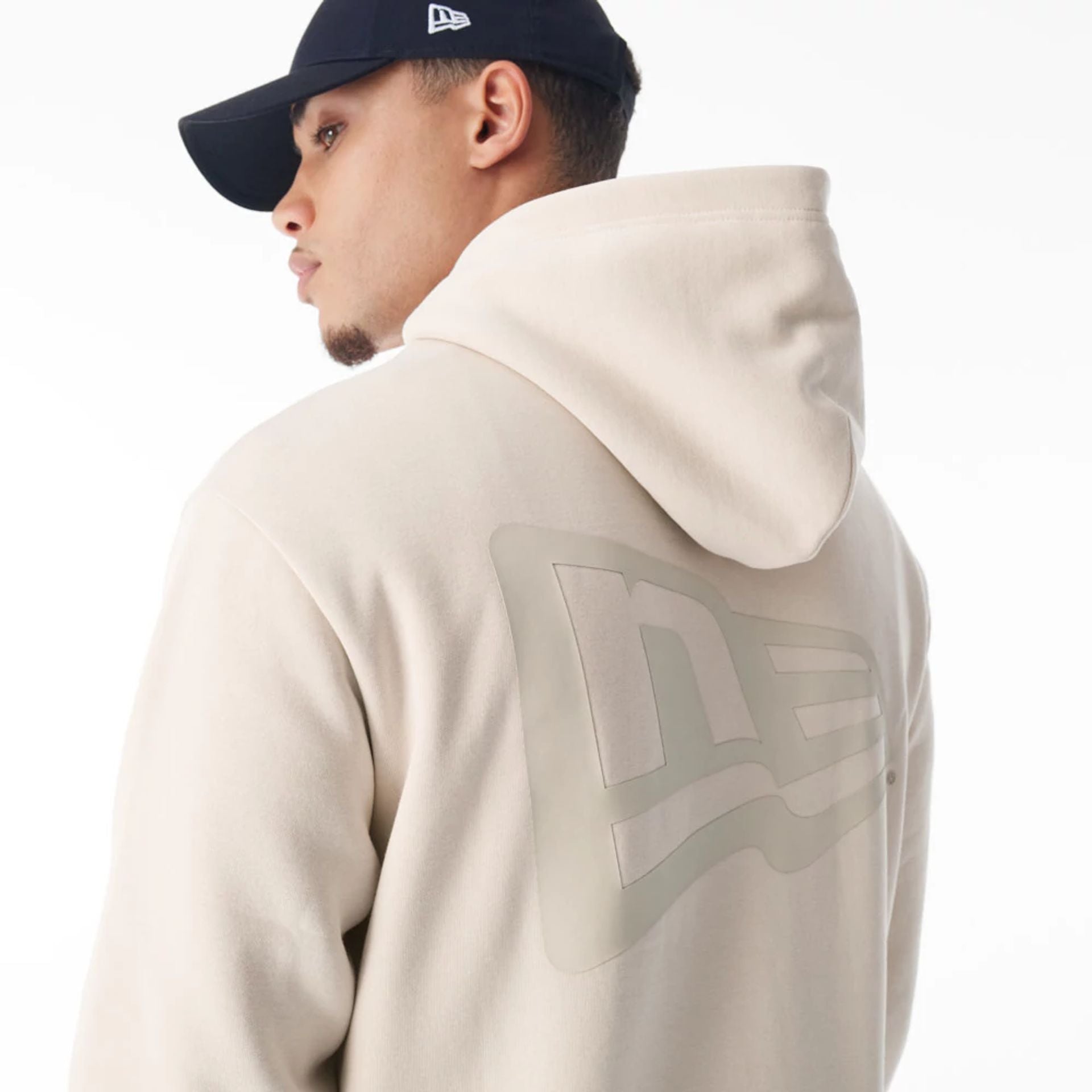 The Male model is wearing  New Era Flag Cream Oversized Pullover Hoodie  2