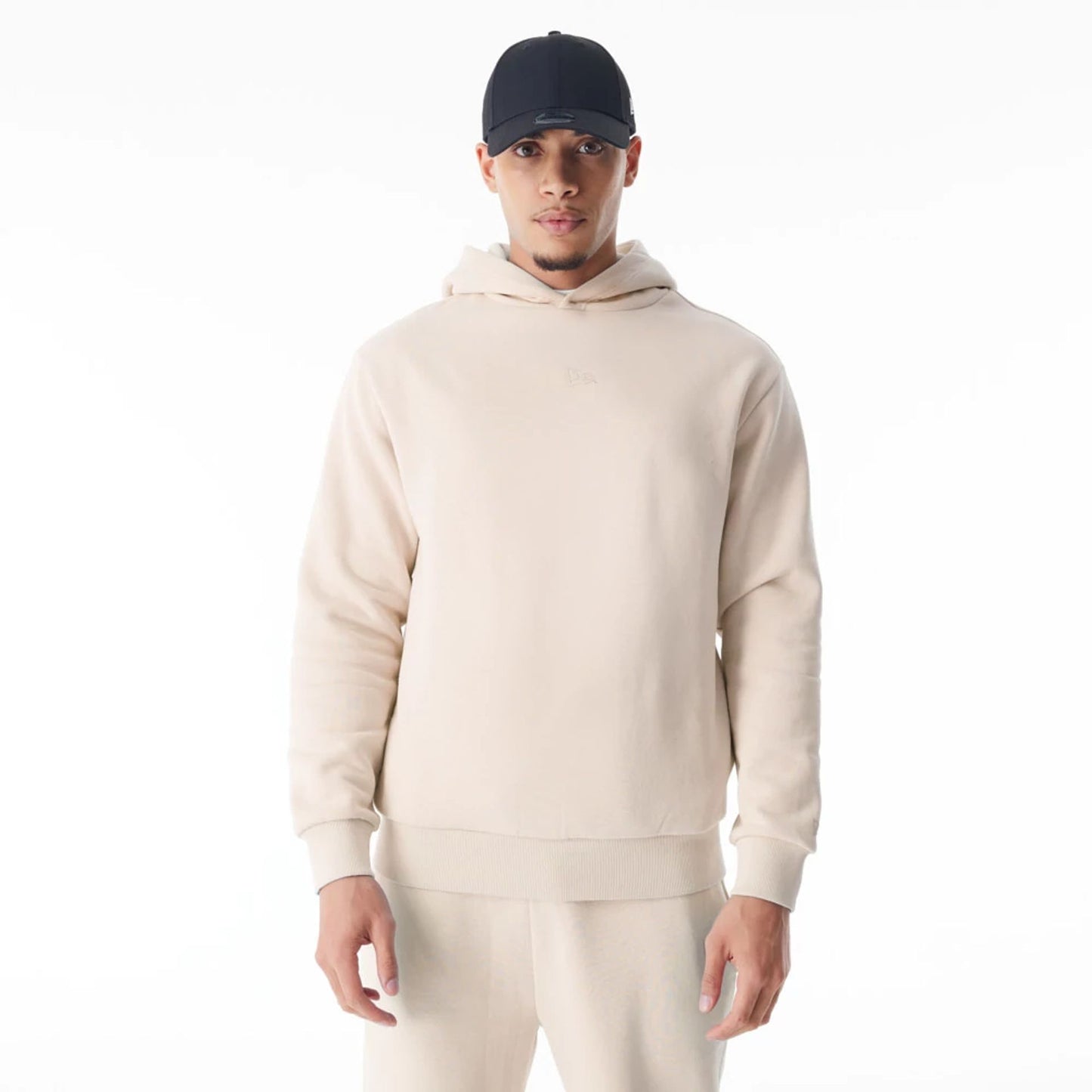 The Male model is wearing  New Era Flag Cream Oversized Pullover Hoodie  1