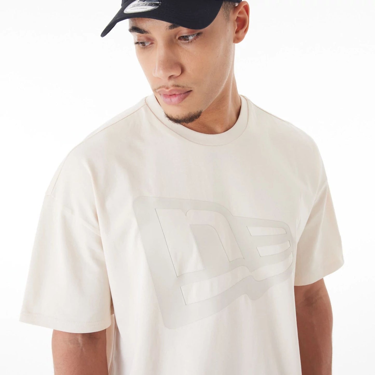 The Male model is wearing  New Era Flag Cream Oversized T-Shirt  5