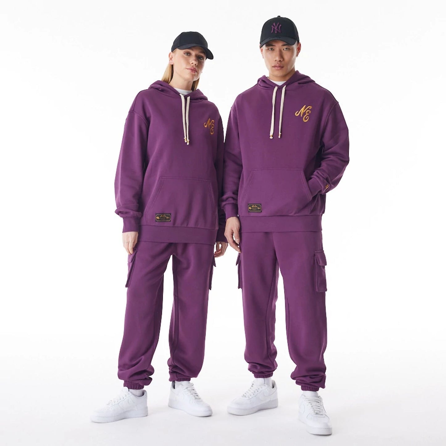 The Male model is wearing  New Era Script Logo Dark Purple Oversized Pullover Hoodie  5