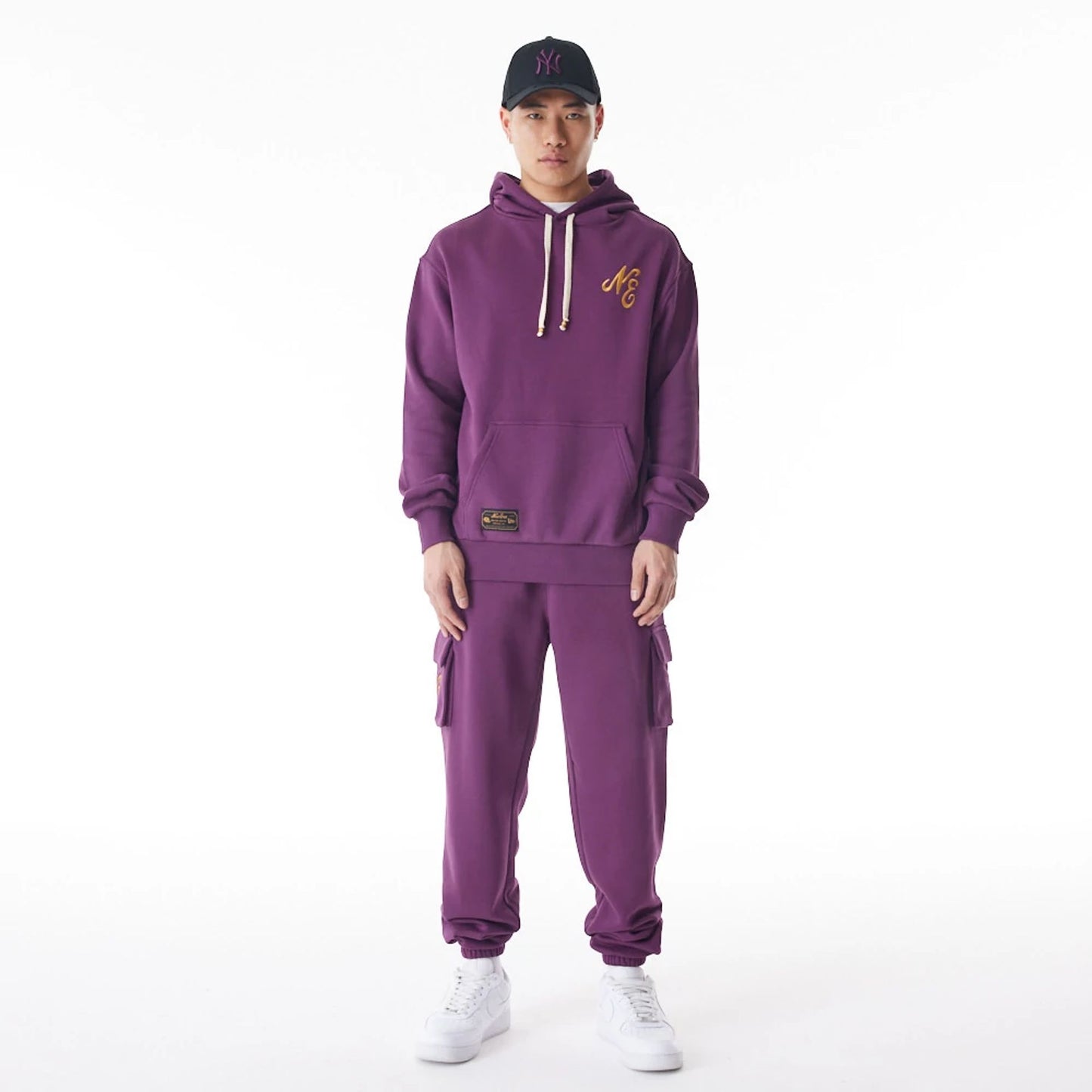 The Male model is wearing  New Era Script Logo Dark Purple Oversized Pullover Hoodie  6