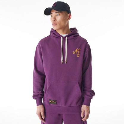 The Male model is wearing  New Era Script Logo Dark Purple Oversized Pullover Hoodie  2