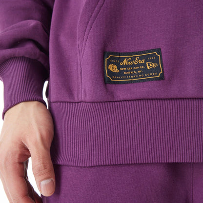 The Male model is wearing  New Era Script Logo Dark Purple Oversized Pullover Hoodie  11