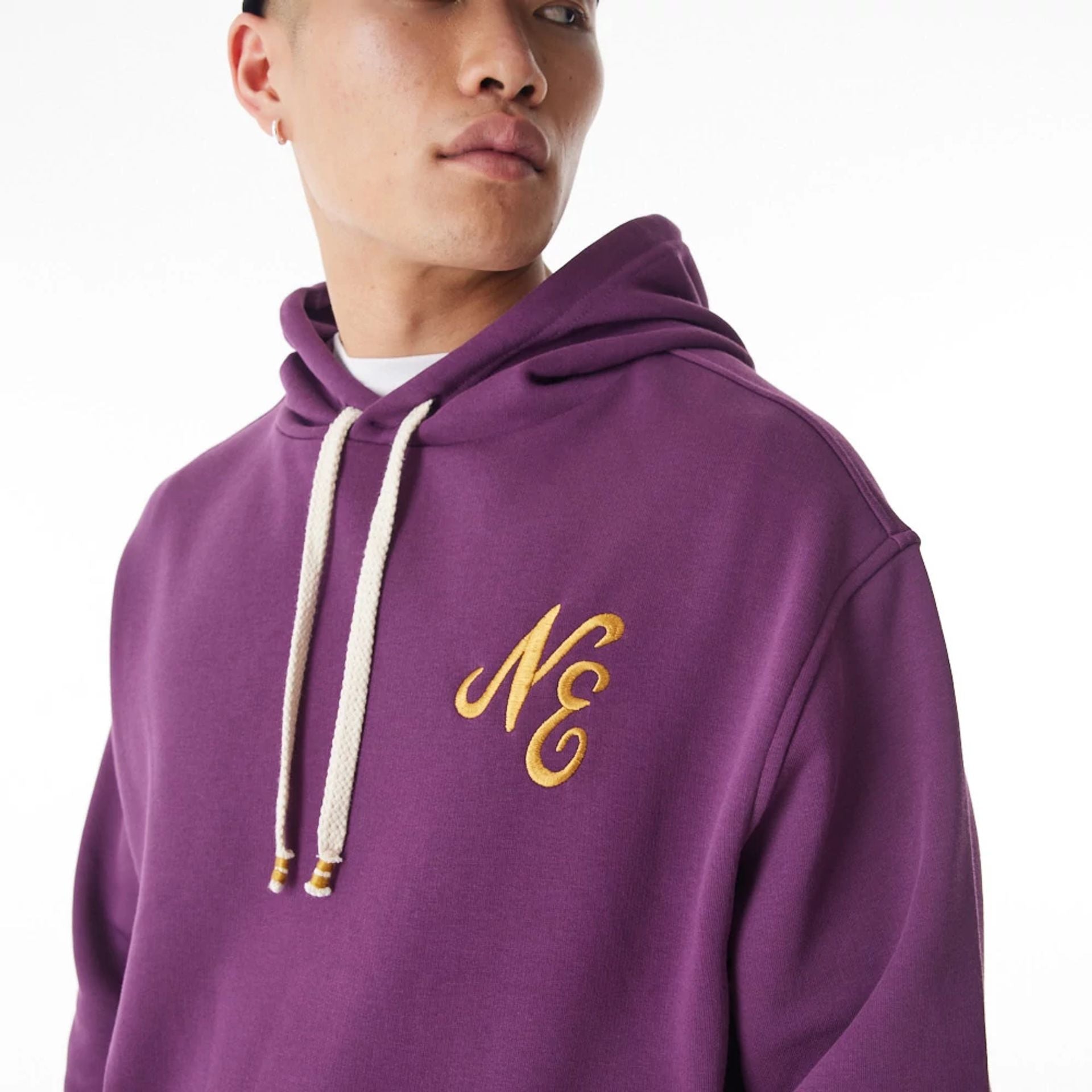 The Male model is wearing  New Era Script Logo Dark Purple Oversized Pullover Hoodie  13