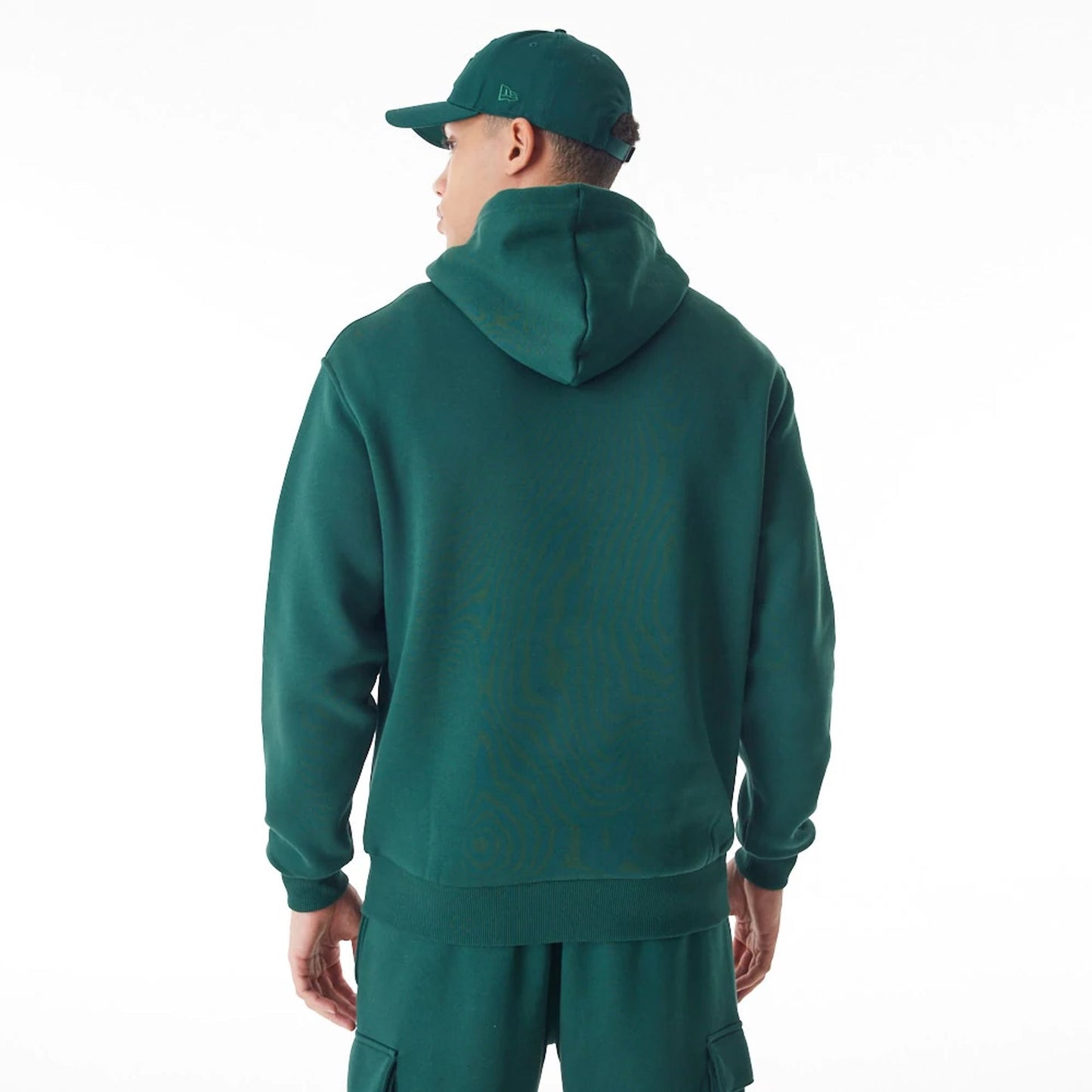 The Male model is wearing  New Era Script Logo Dark Green Oversized Pullover Hoodie  7