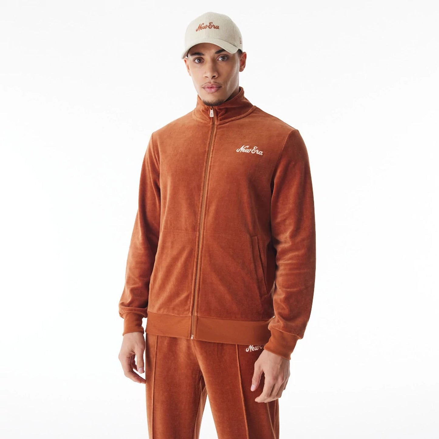 The Male model is wearing  New Era Velour Brown Track Jacket  2