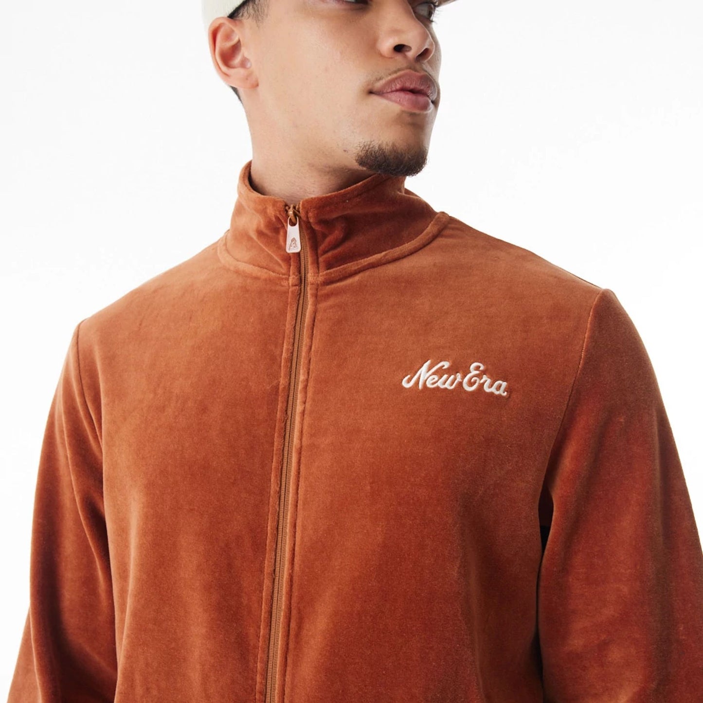 The Male model is wearing  New Era Velour Brown Track Jacket  12