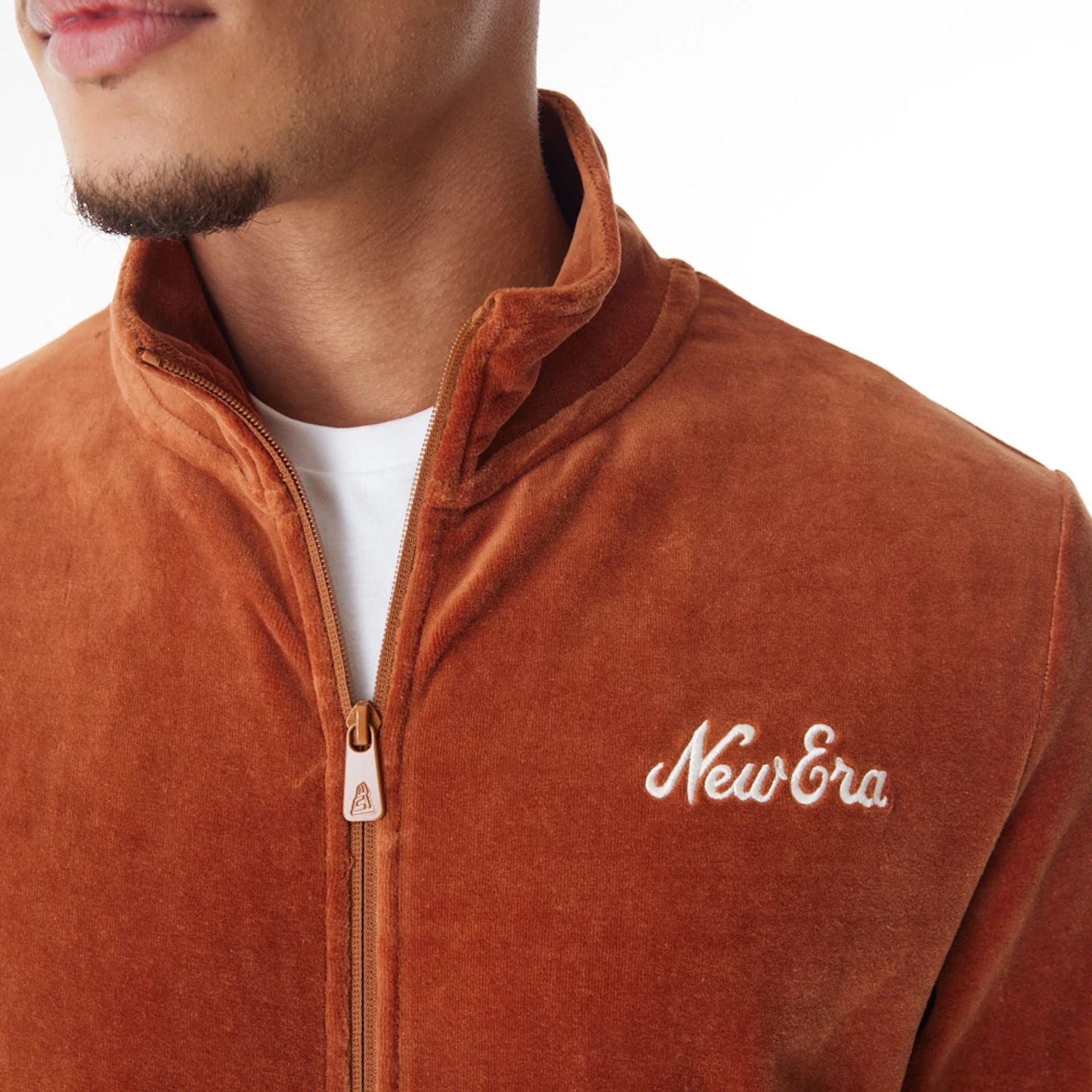 The Male model is wearing  New Era Velour Brown Track Jacket  13