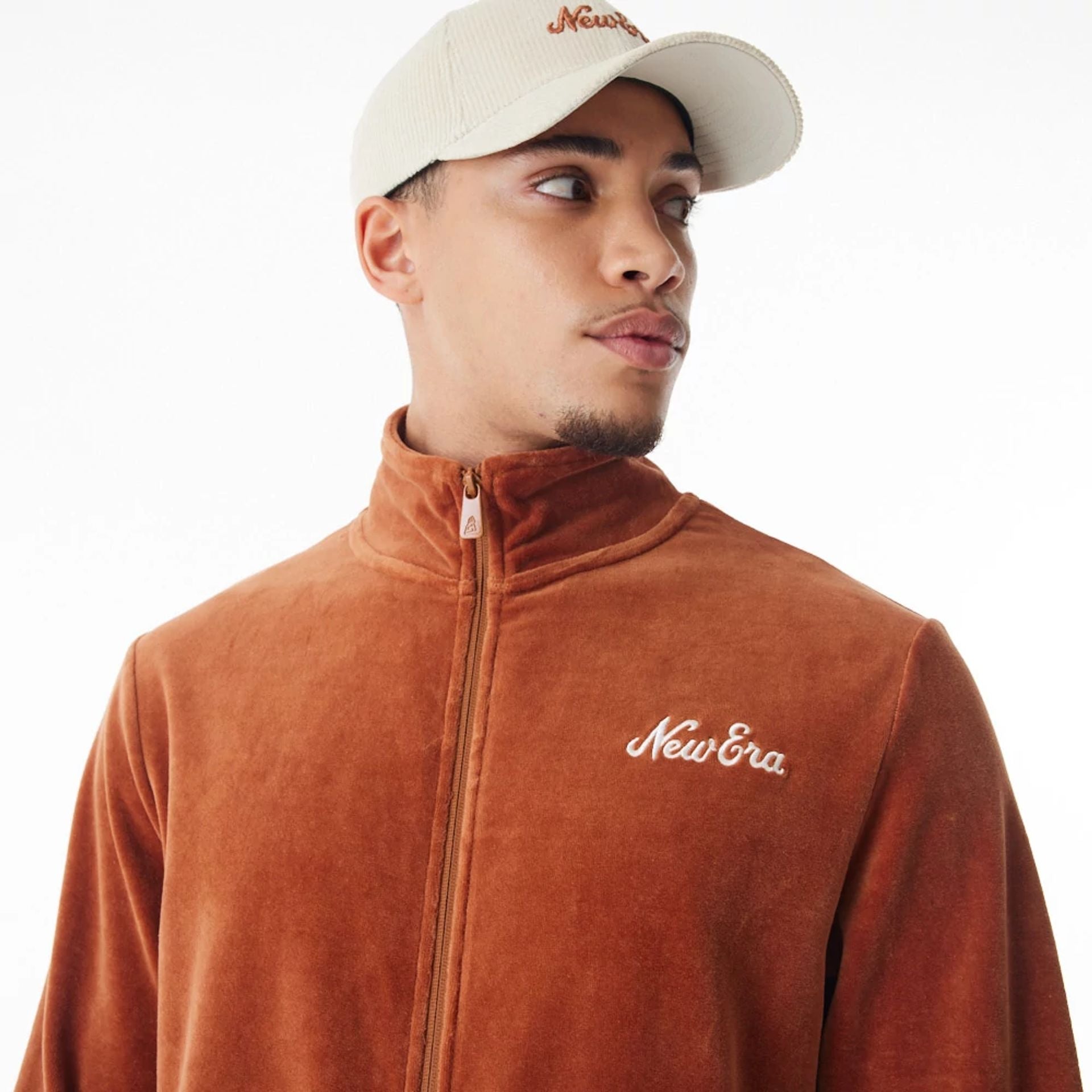 The Male model is wearing  New Era Velour Brown Track Jacket  14