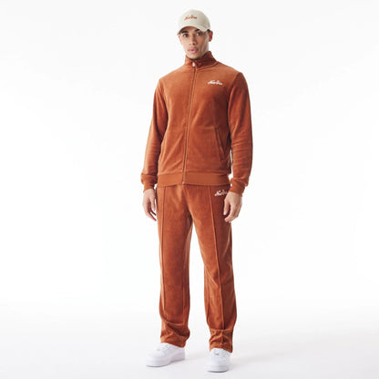 The Male model is wearing  New Era Velour Brown Track Joggers  4