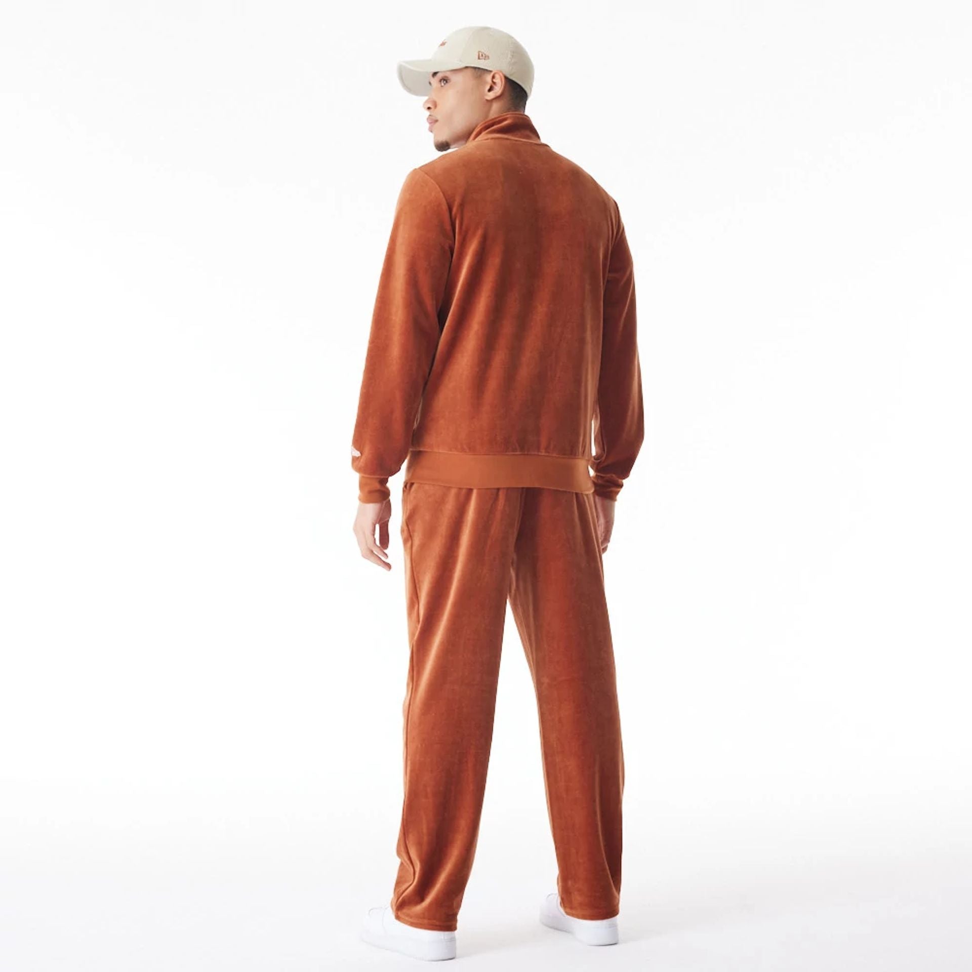 The Male model is wearing  New Era Velour Brown Track Joggers  5