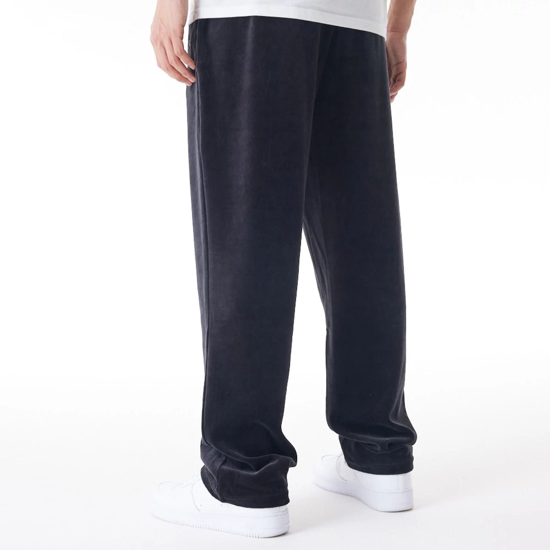 The Male model is wearing  New Era Velour Black Track Joggers  2