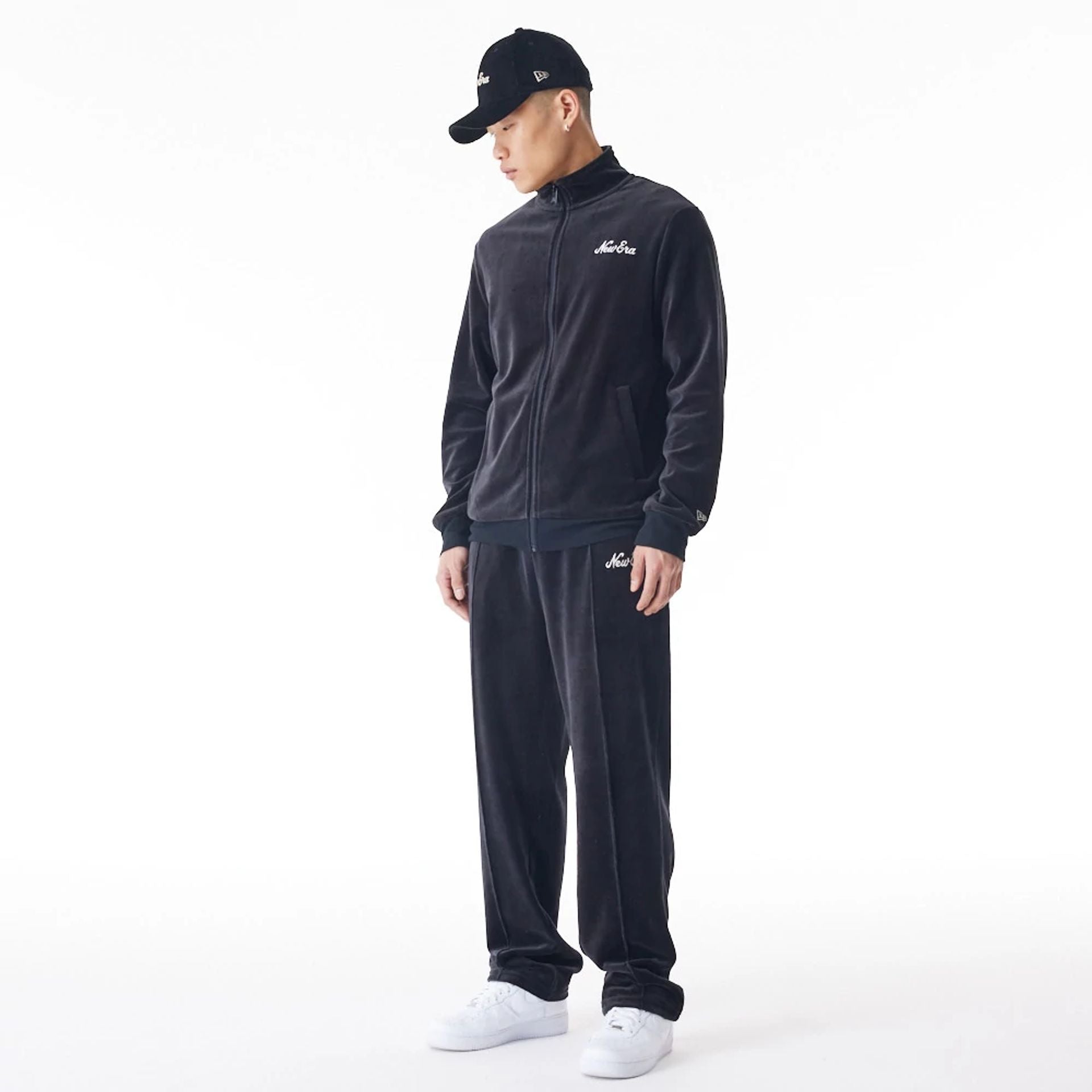 The Male model is wearing  New Era Velour Black Track Joggers  6