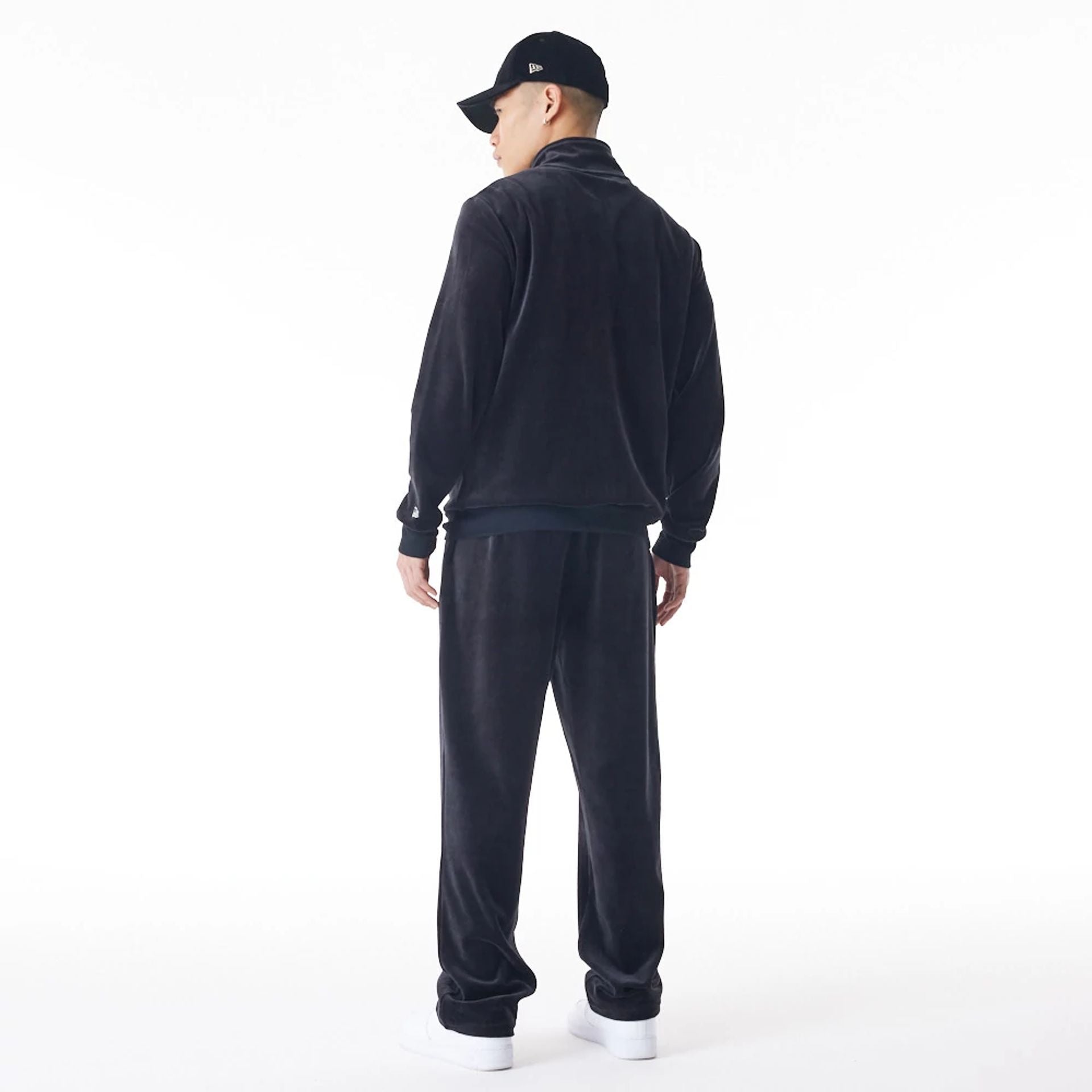 The Male model is wearing  New Era Velour Black Track Joggers  4