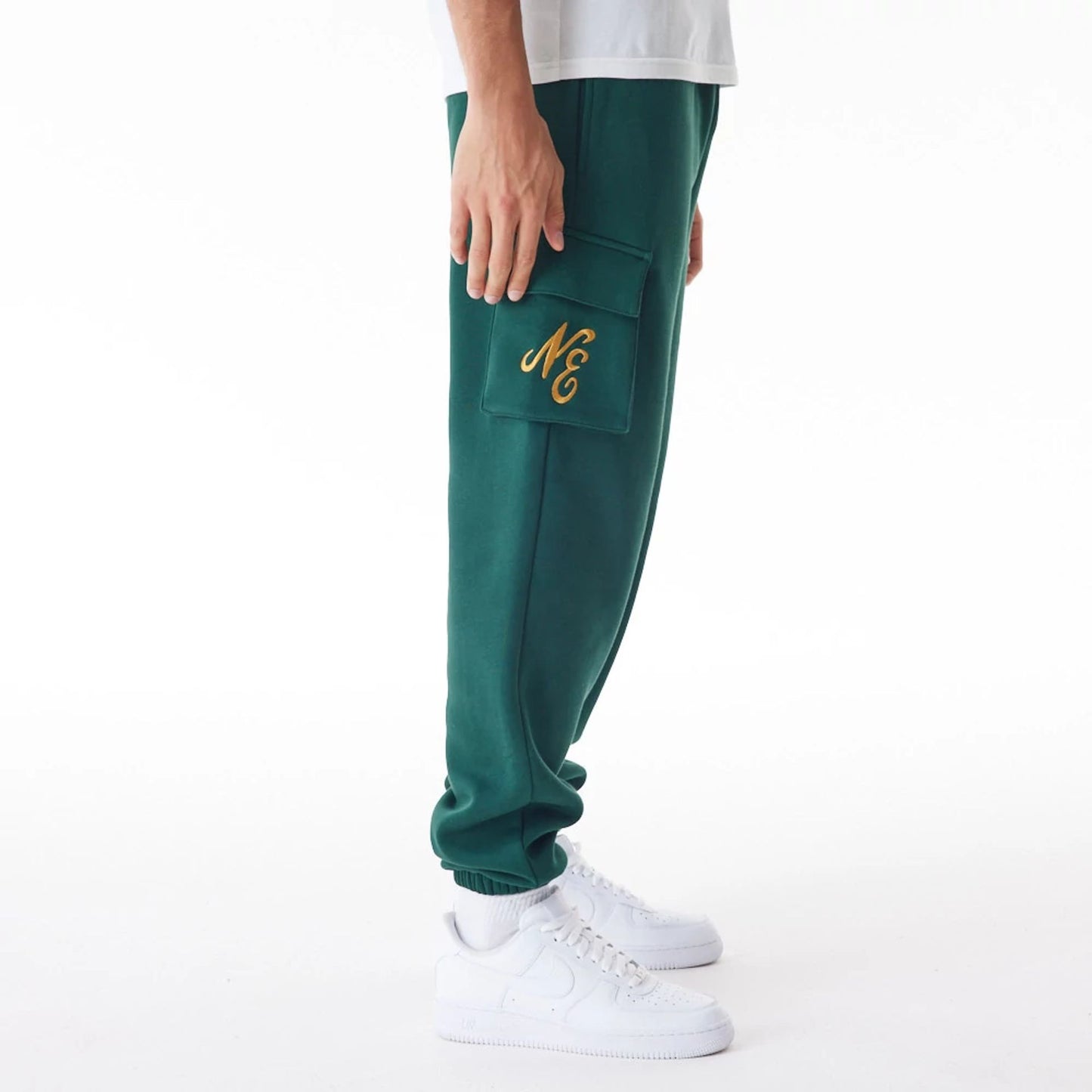 The Male model is wearing  New Era Script Cargo Dark Green Joggers  3