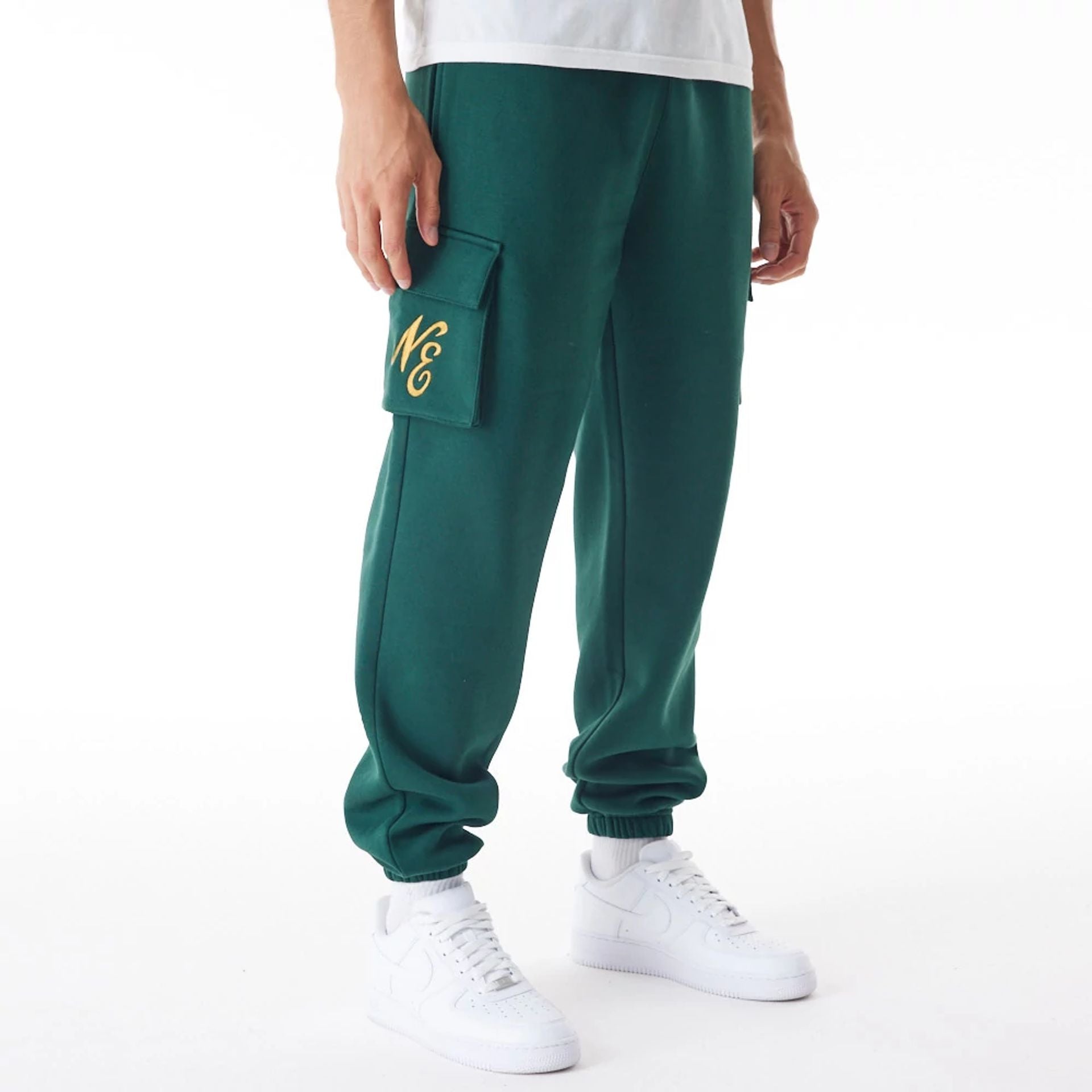 The Male model is wearing  New Era Script Cargo Dark Green Joggers  1