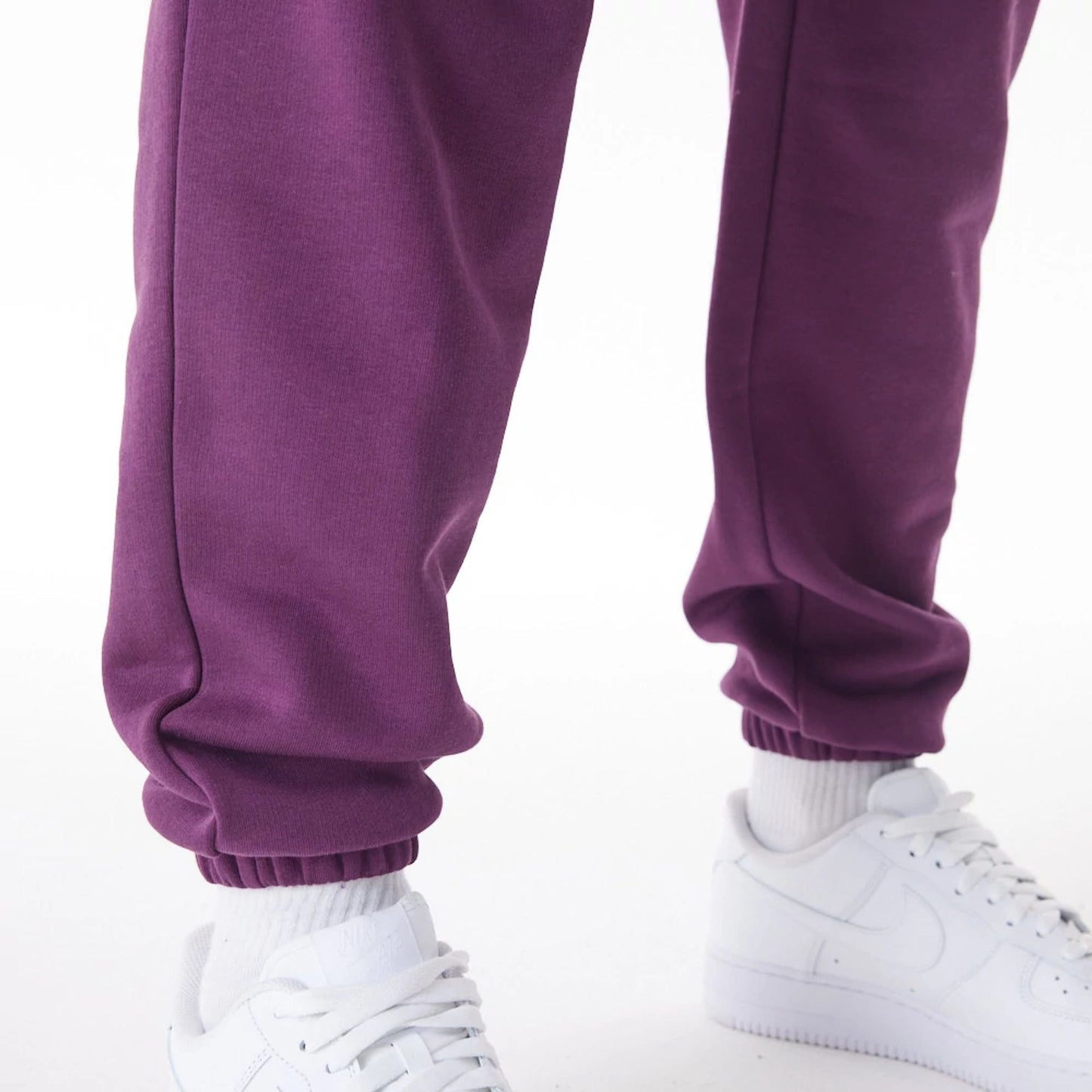 The Male model is wearing  New Era Script Cargo Dark Purple Joggers  8