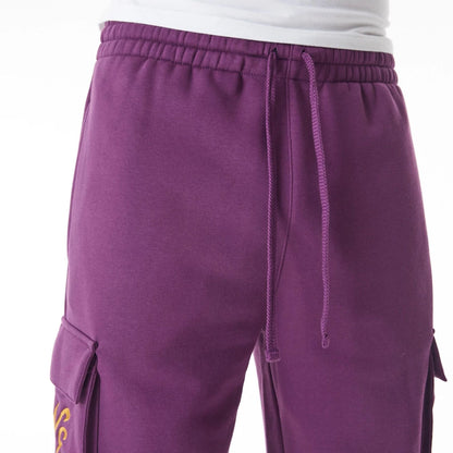 The Male model is wearing  New Era Script Cargo Dark Purple Joggers  4