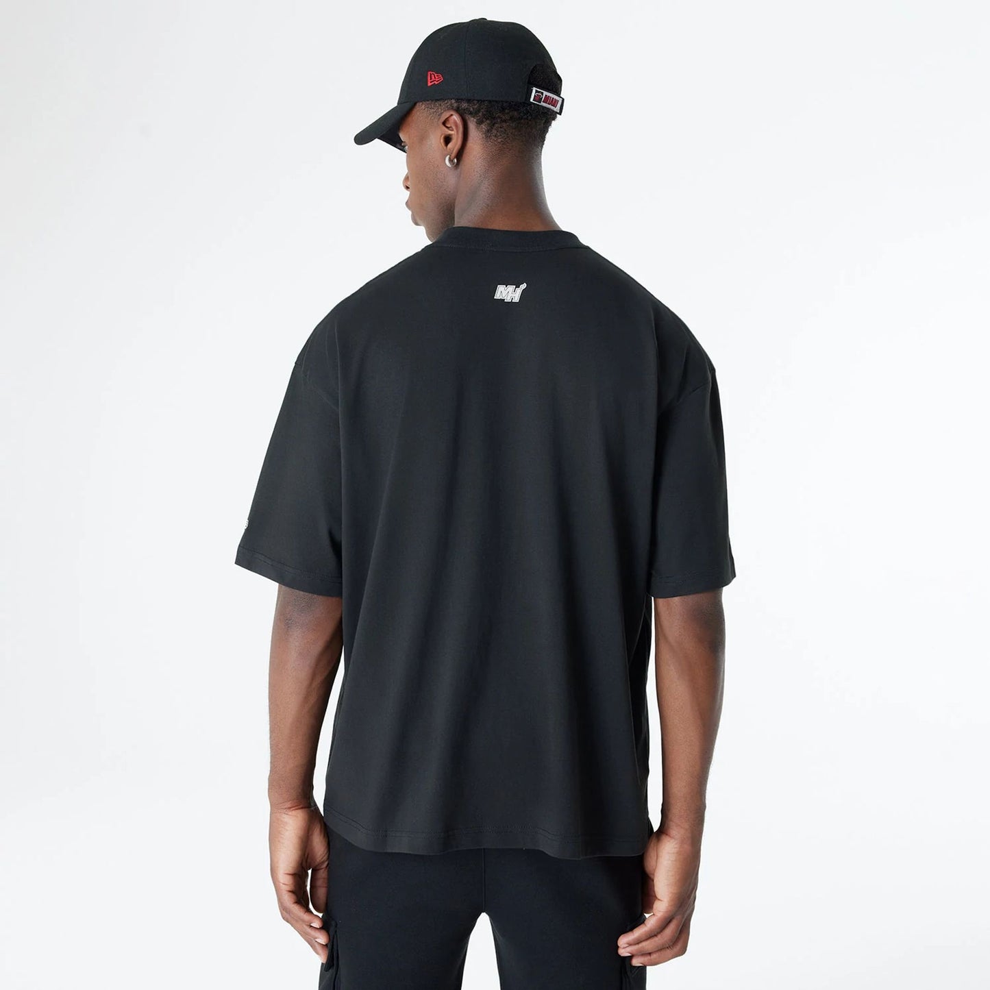 The Male model is wearing Miami Heat Bristol Studio x NBA Black Oversized T-Shirt 2