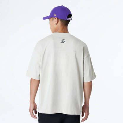 The Male model is wearing LA Lakers Bristol Studio x NBA Light Beige Oversized T-Shirt 2