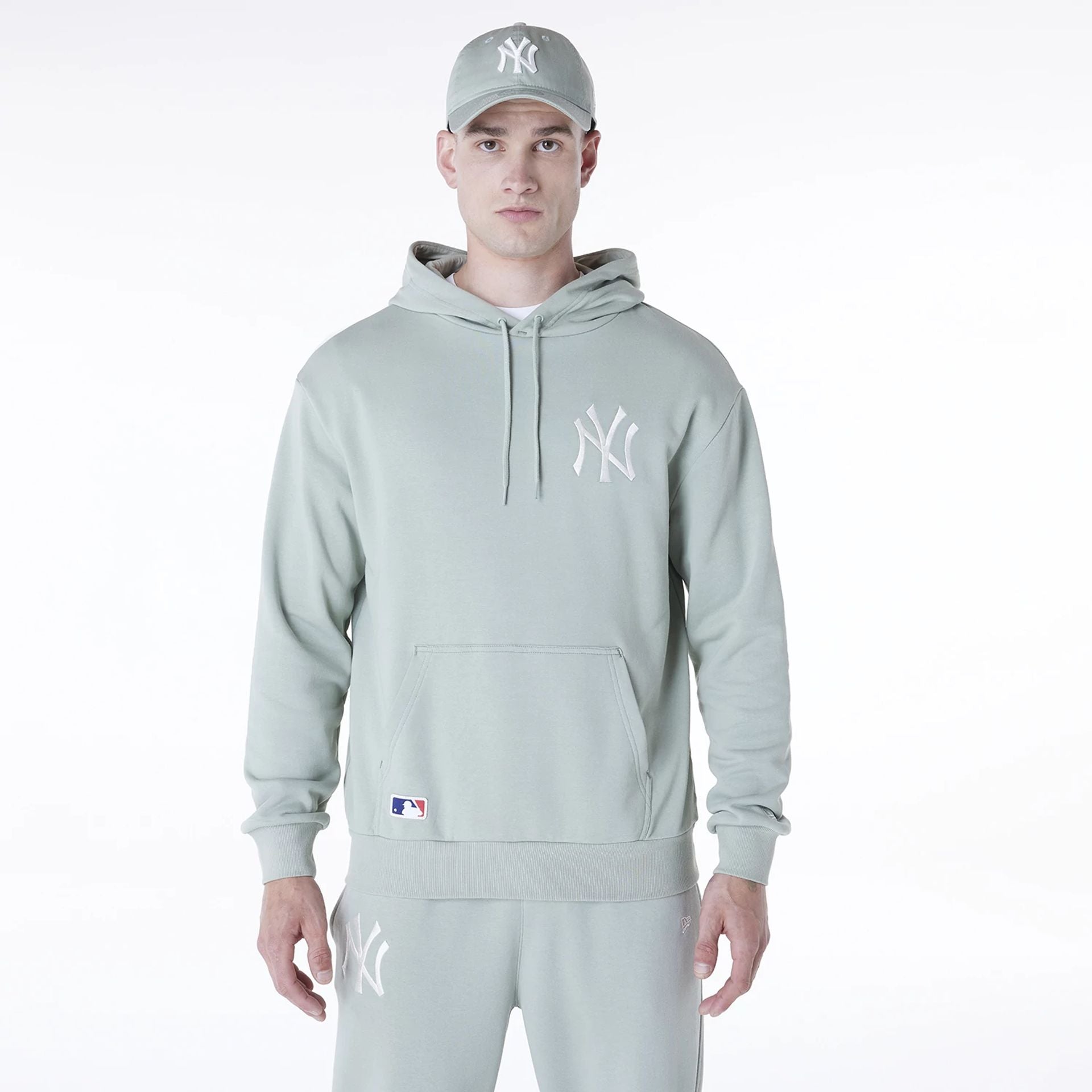 The Male model is wearing New York Yankees MLB League Essential Pastel Green Oversized Pullover Hoodie 1