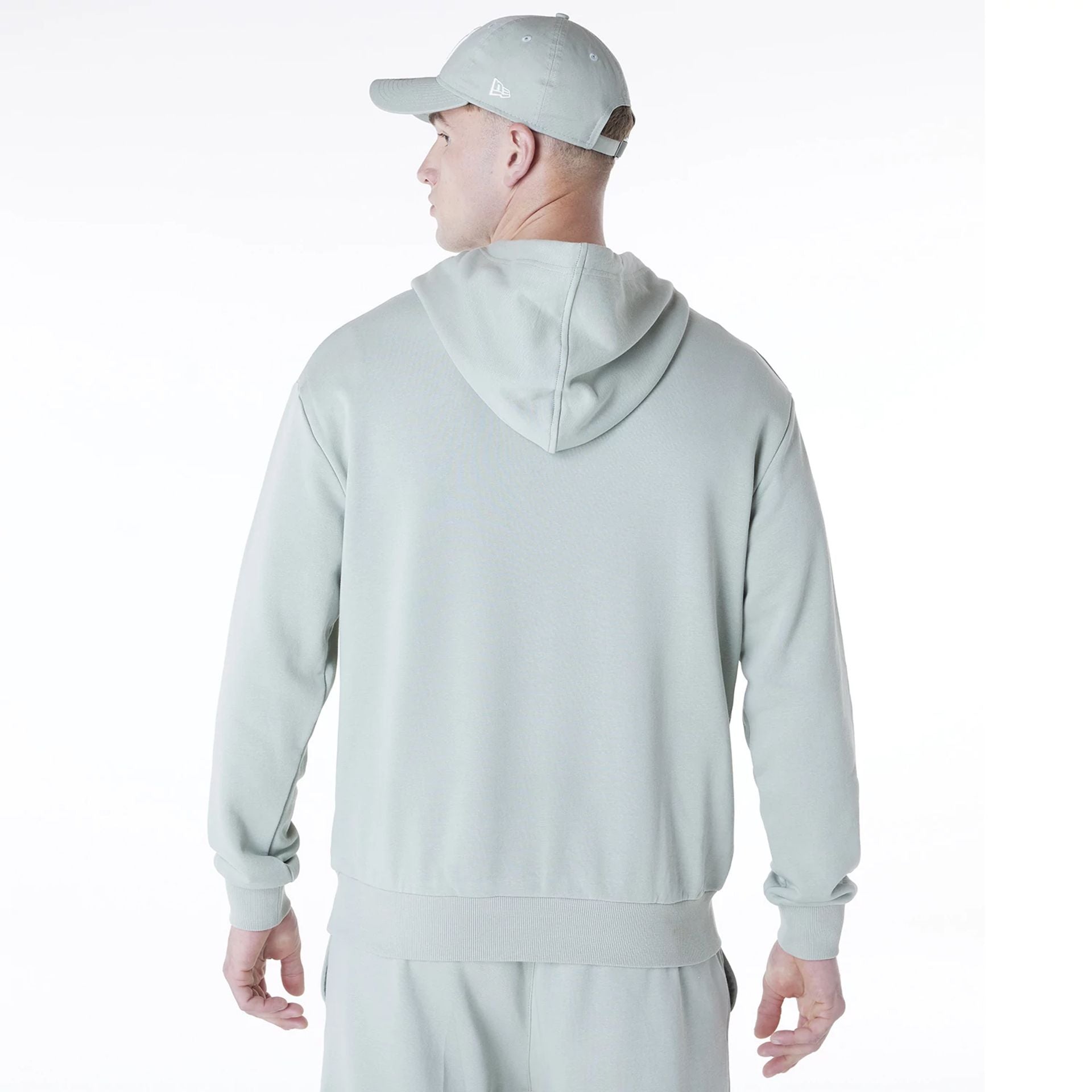 The Male model is wearing New York Yankees MLB League Essential Pastel Green Oversized Pullover Hoodie 2