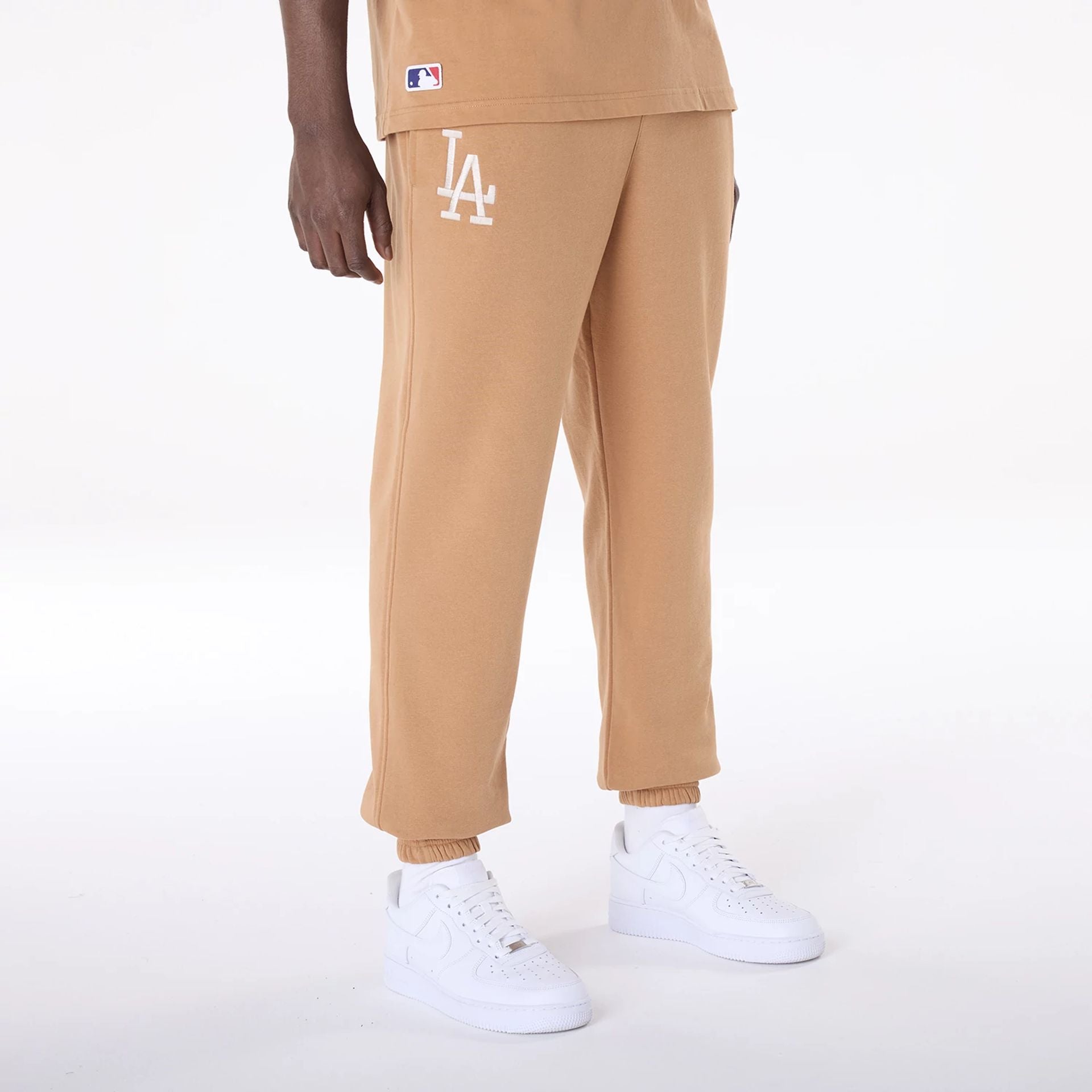 The Male model is wearing LA Dodgers MLB League Essential Dark Beige Fleece Joggers 2