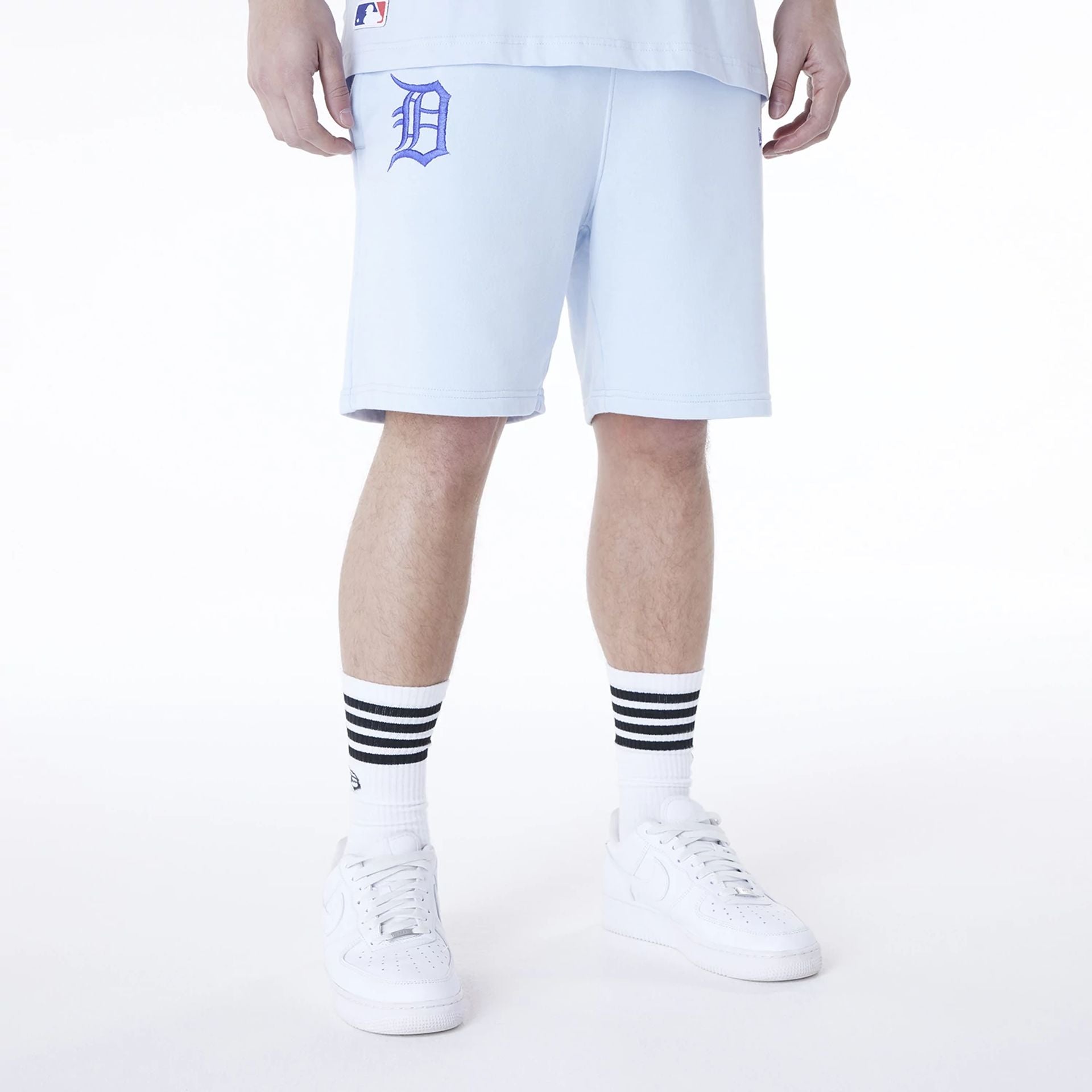 The Male model is wearing Detroit Tigers MLB League Essential Pastel Blue Shorts 1